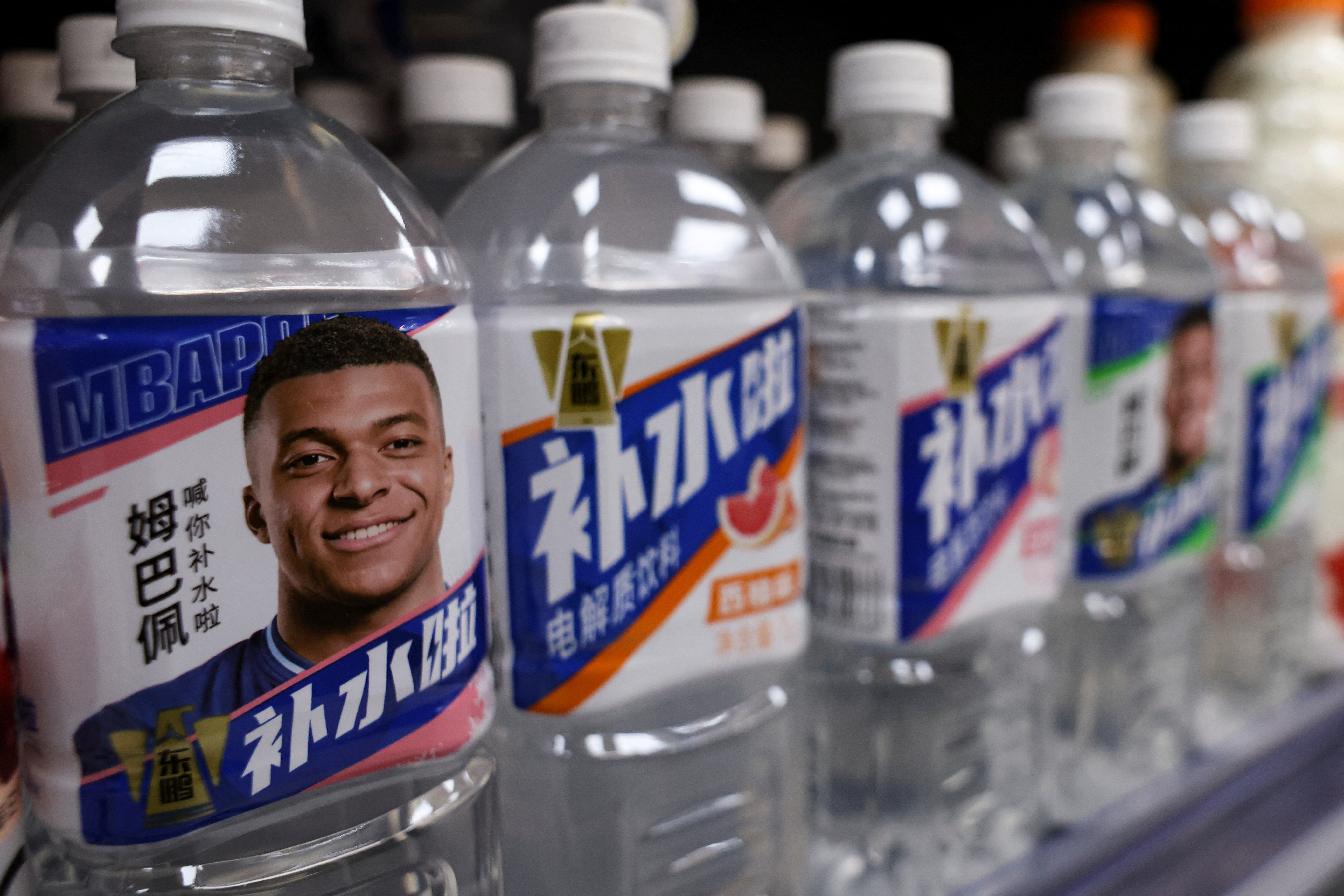 Bottled drinks by Eastroc Beverage with images of French soccer player Kylian Mbappe. REUTERS/Tingshu Wang