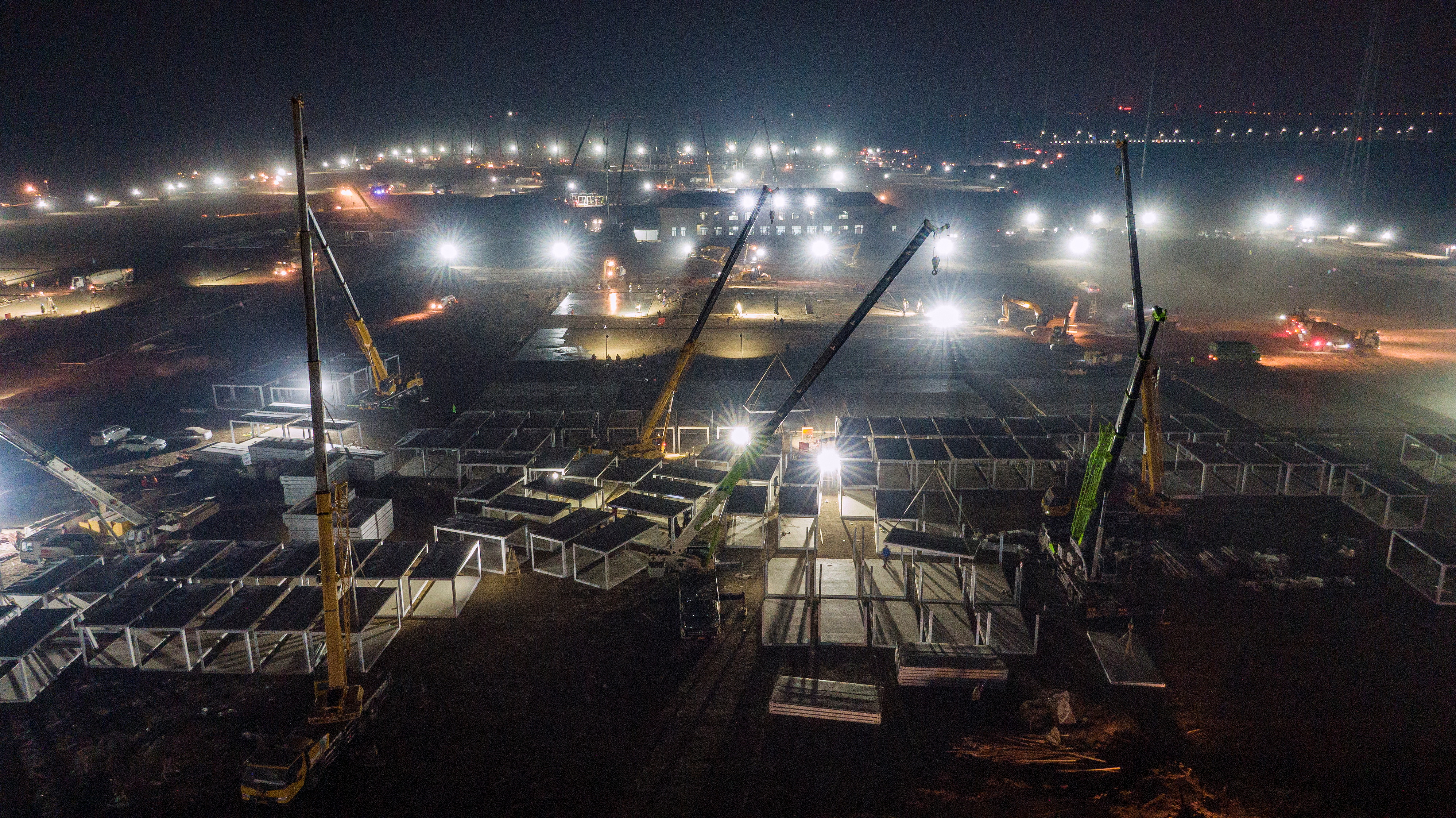 General view shows cranes and workers at the construction site of a centralised quarantine facility in Shijiazhuang