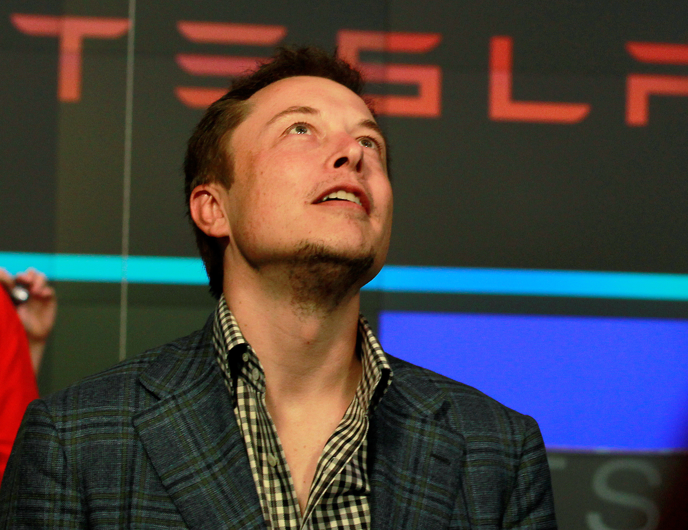 elon musk FILE PHOTO: CEO of Tesla Motors Elon Musk reacts following the company's initial public offering at the NASDAQ market in New York