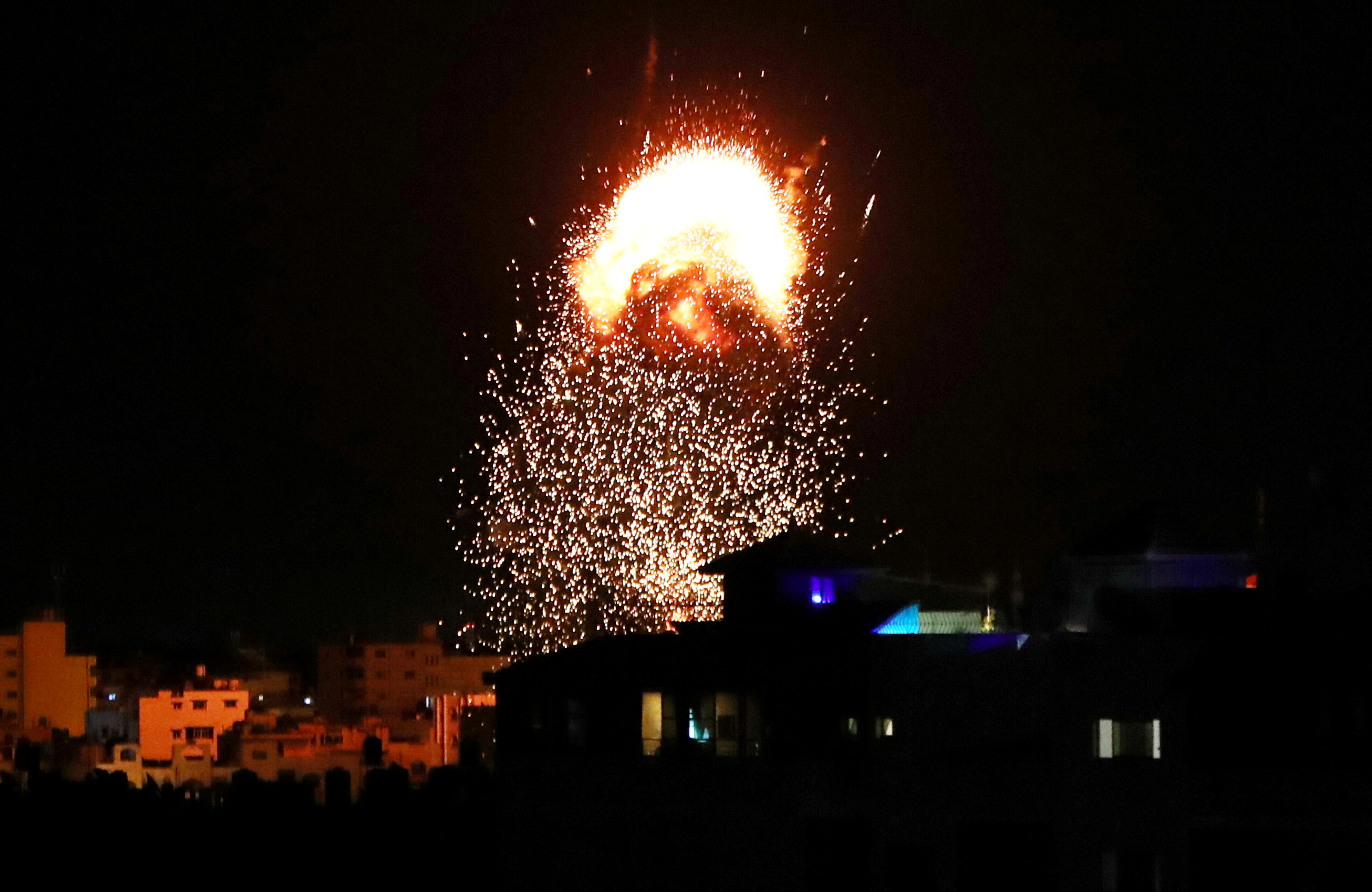 Smoke and flames rise above a building during Israeli air strikes, amid a flare-up of Israeli-Palestinian fighting, in Gaza City
