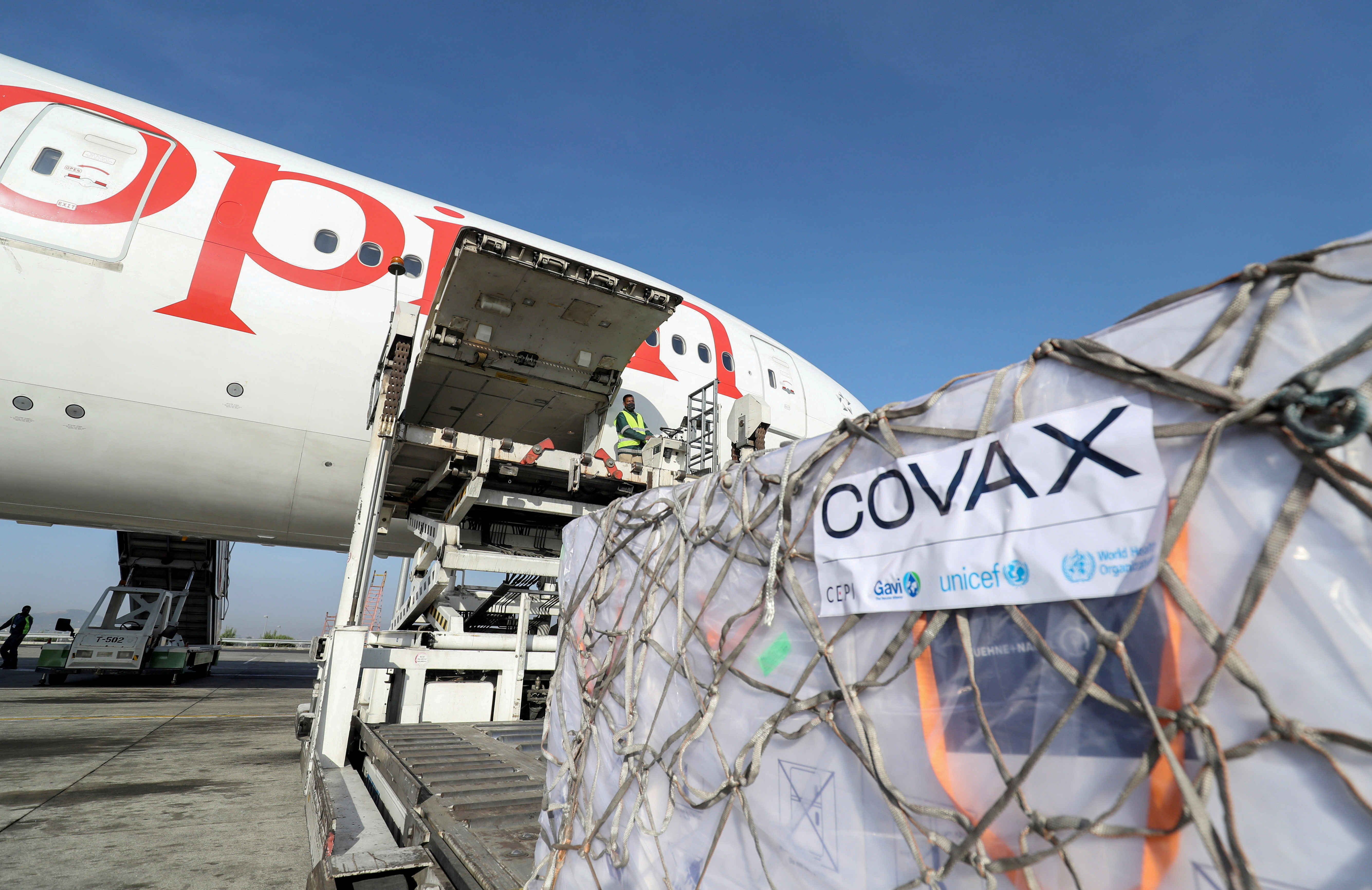 FILE PHOTO: AstraZeneca coronavirus vaccines from the COVAX vaccine-sharing scheme are unloaded from a cargo plane at Bole International Airport in Ethiopia