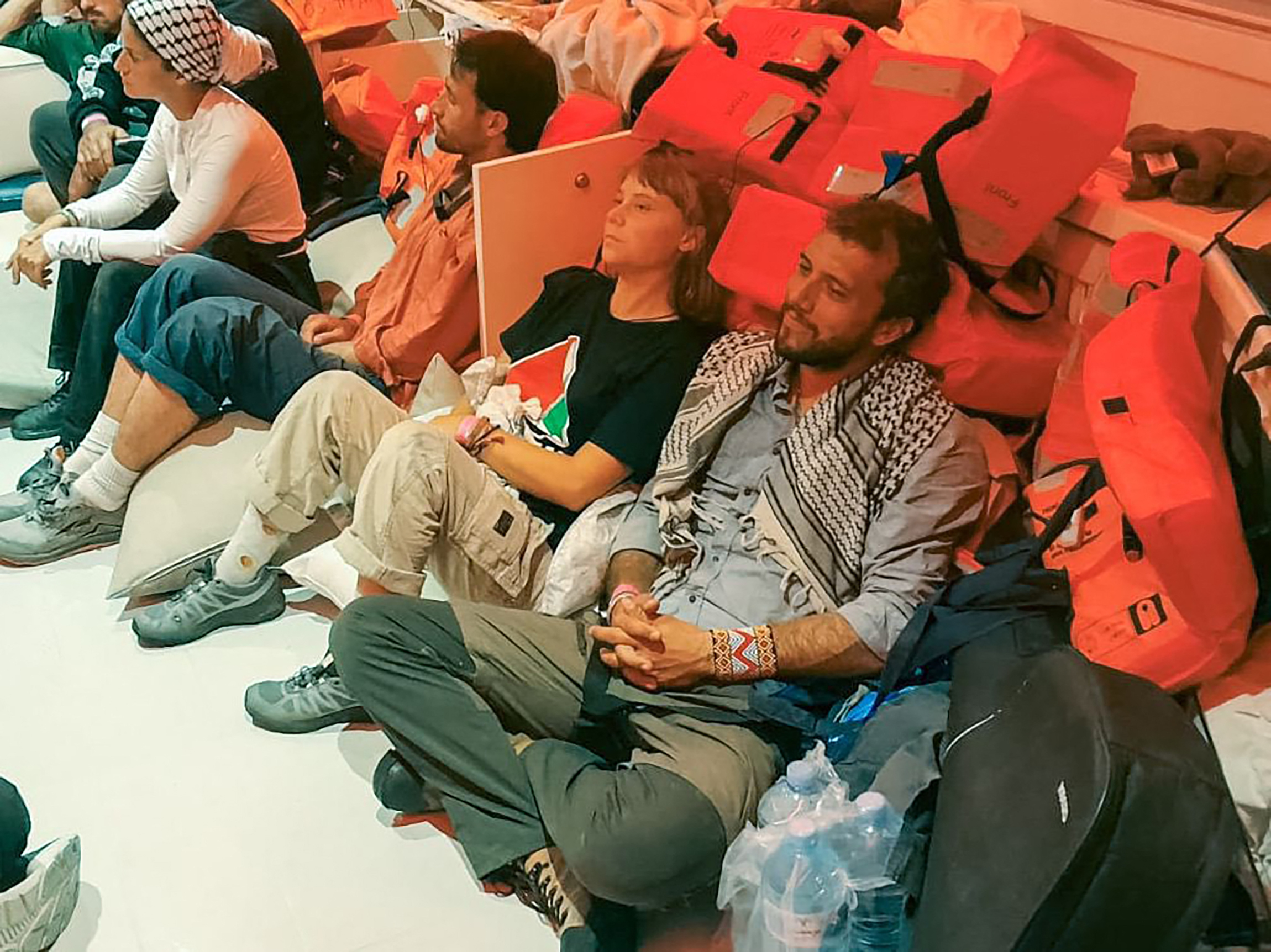 This handout picture released by the Israeli Foreign Ministry shows Swedish climate activist Greta Thunberg (C) and Brazilian activist Thiago Avila. Photo by