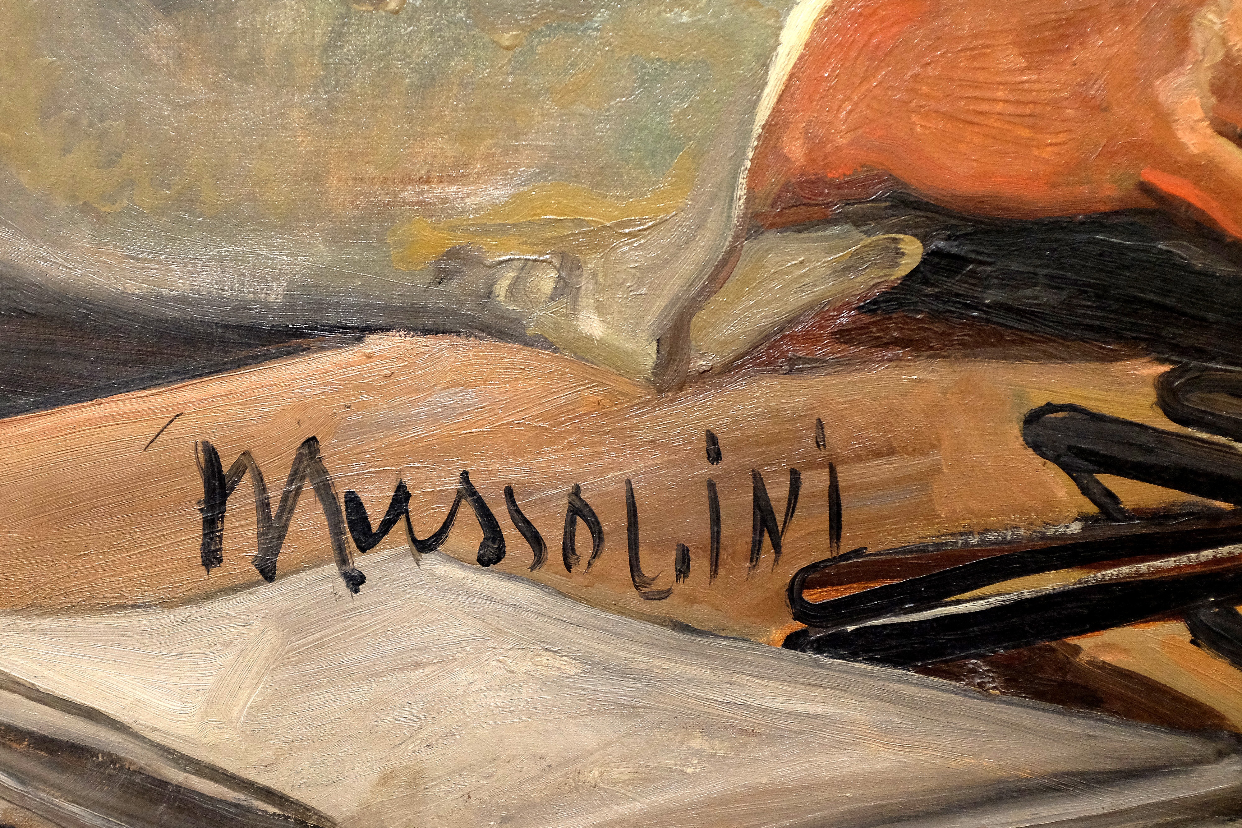 A picture shows a detail of a portrait of Mussolini (1934)