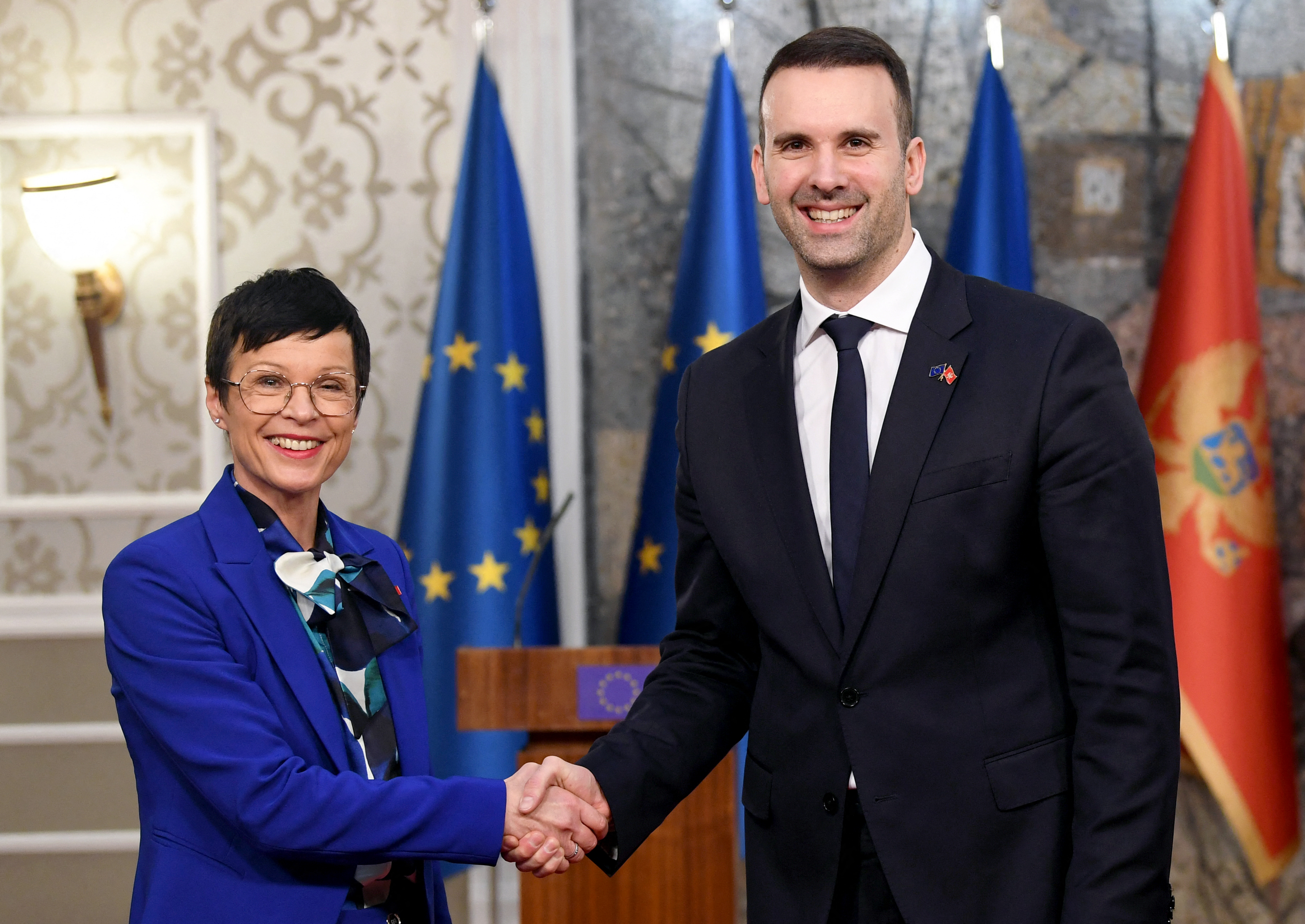 European Commissioner for Enlargement, Marta Kos (L) shakes hands with Prime Minister of Montenegro, Milojko Spajic (R) prior to their meeting in Podgorica, on January 16, 2025. (Photo by SAVO PRELEVIC / AFP)