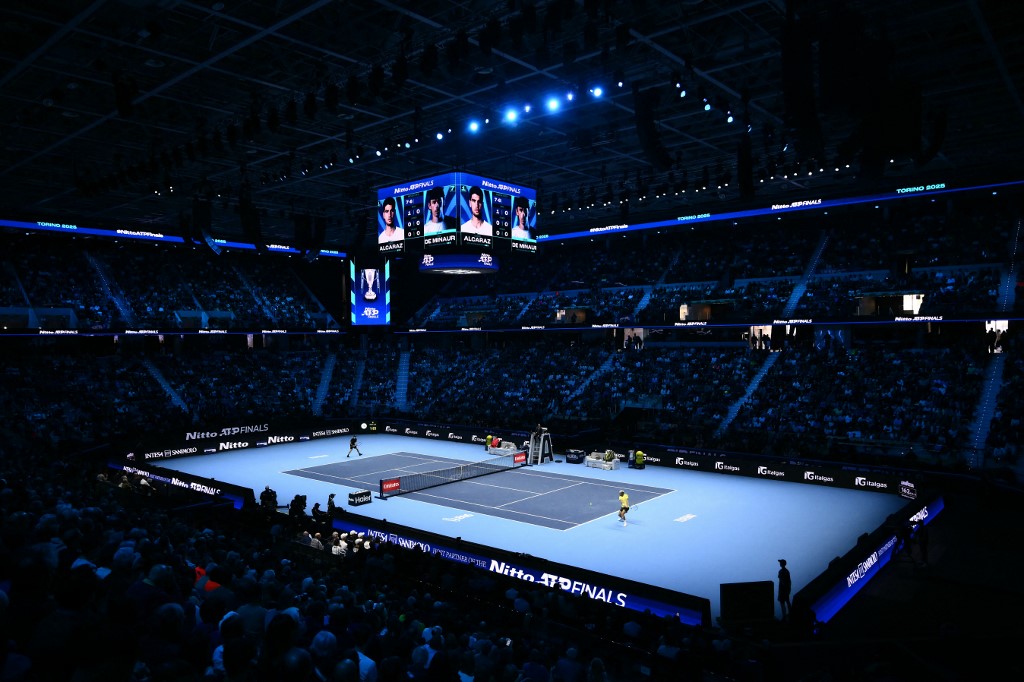 Spain's Carlos Alcaraz (R) hits a return against Australia's Alex De Minaur at the ATP Finals tennis tournament in Turin on November 9, 2025. (Photo by Marco BERTORELLO / AFP)