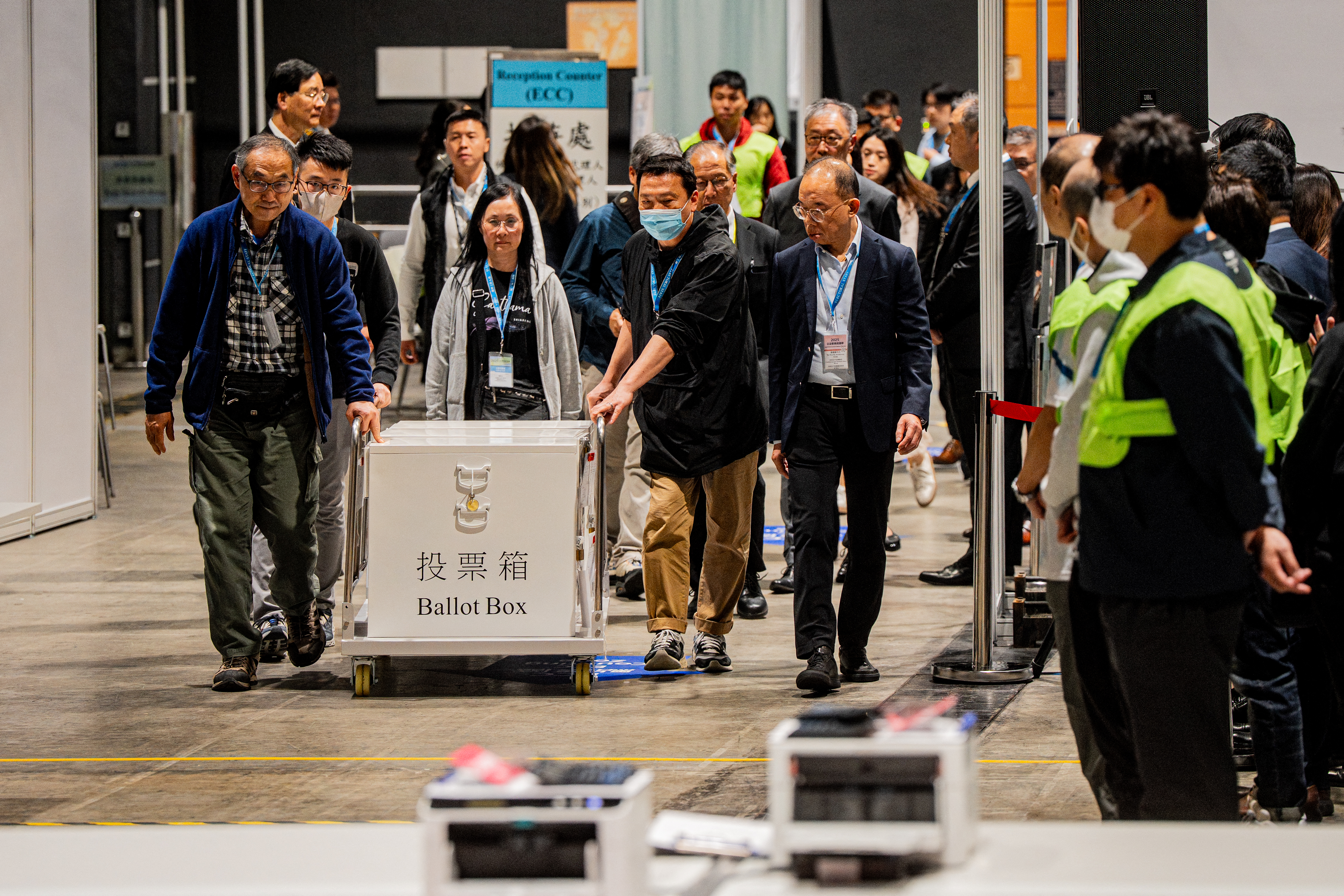 The first ballot box is delivered to the counting station after polls closed in the Legislative Council elections in Hong Kong, China, on December 7, 2025. (Photo by )