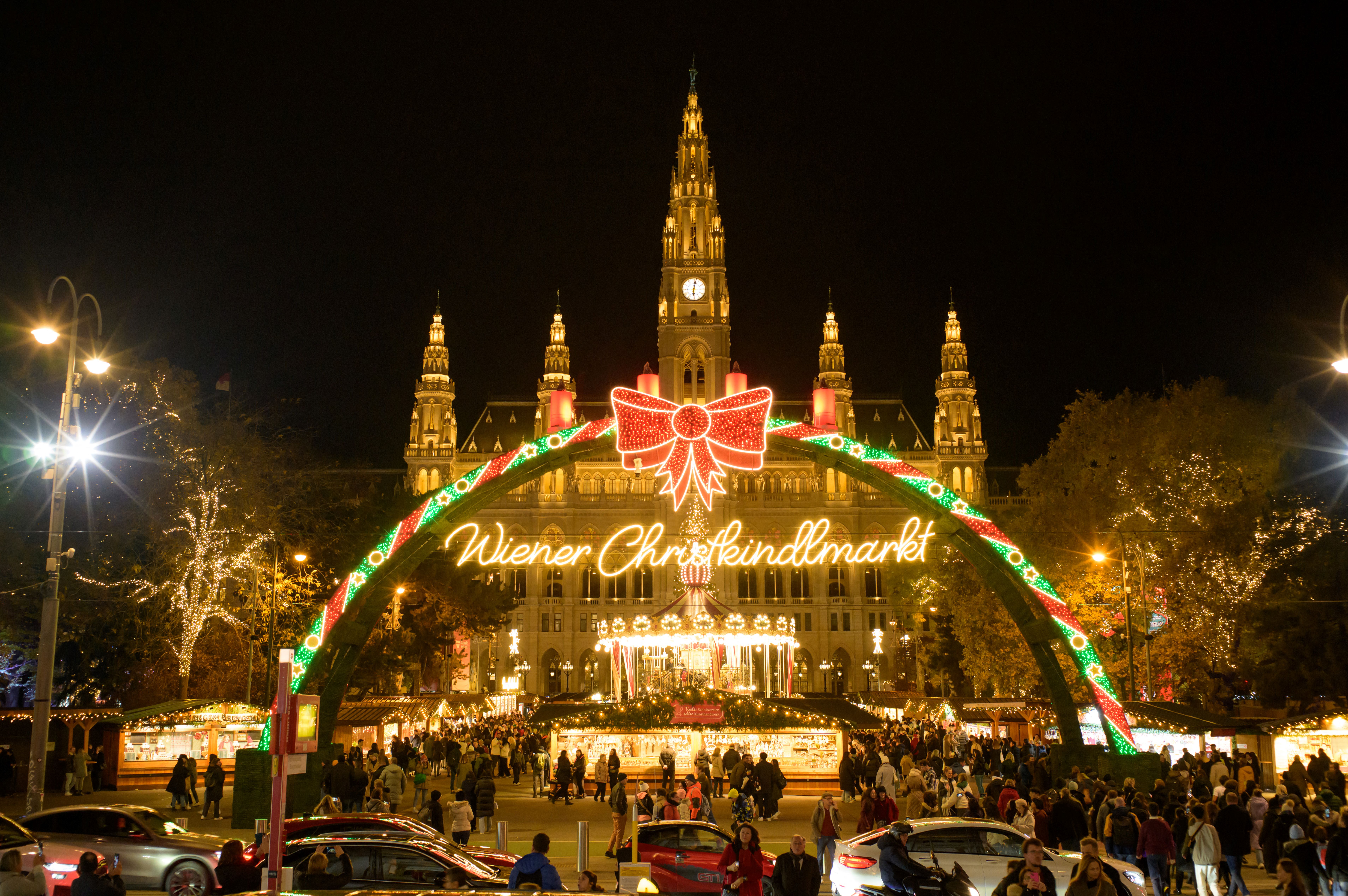 Visitors walk at the Christmas Market outside Vienna's City Hall, Austria, on November 14, 2023. (Photo by Joe Klamar / AFP)