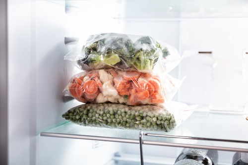 Plastic Bags With Frozen Vegetables In Refrigerator