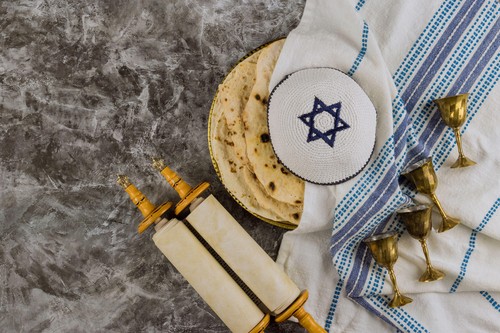 Jewish celebrating symbols holiday with holy religious book in the torah scroll, Pesach Israeli matzah bread and four cup for wine