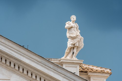 Rome, Italy- Close up of a Roman sculpture on the exterior of (New) St. Peter's Basilica located in Vatican City (an enclave of Rome). Begun by Pope Julius II, St. Peter's is dedicated to the Apostle Peter and is built in the form of a Latin cross filled