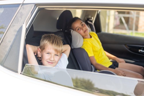 Cute children in car, boy and girl in the car.