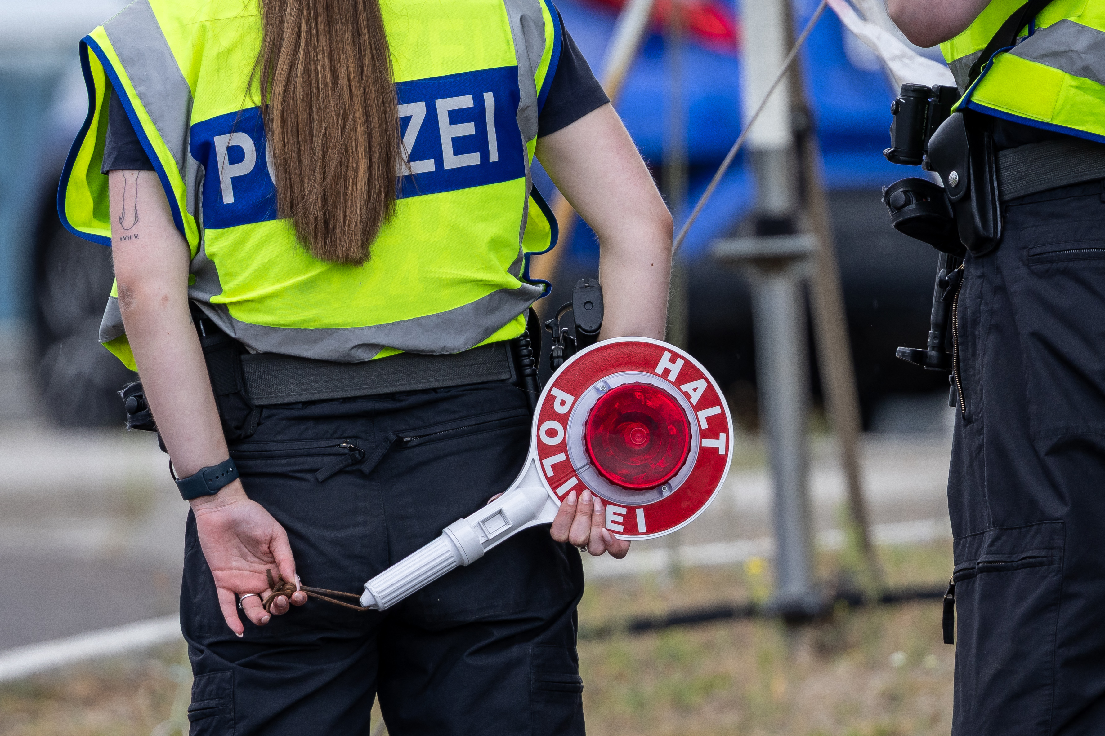 A German police officer holds a signalling disc during controls at the Polish-German border in Frankfurt.