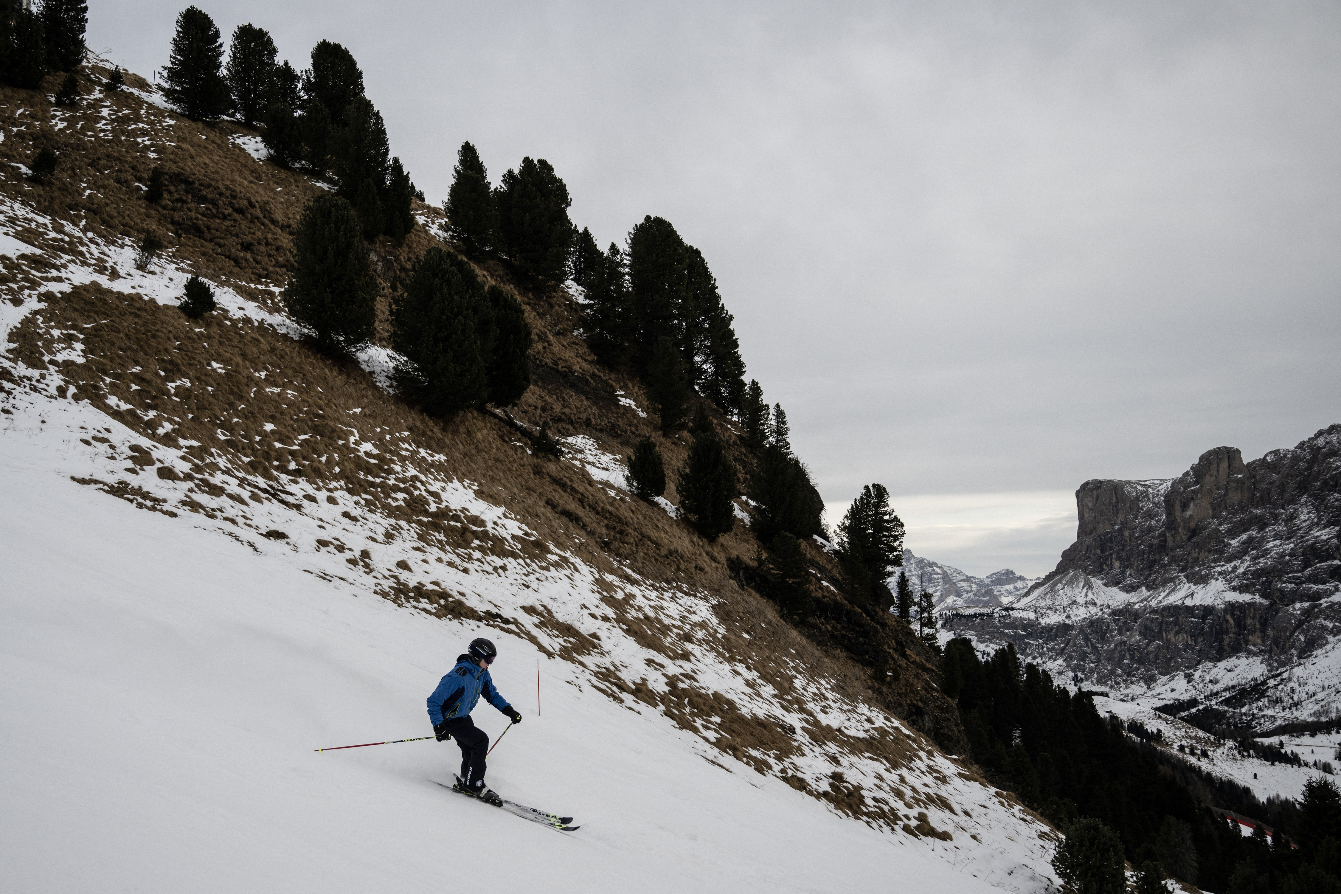A skier goes down a slope in the Piz Sella mountain in Selva di Val Gardena, in the middle of the Dolomites Alps, near Bolzano, South Tyrol, northern Italy, on December 19, 2024. (Photo by MARCO BERTORELLO / AFP)