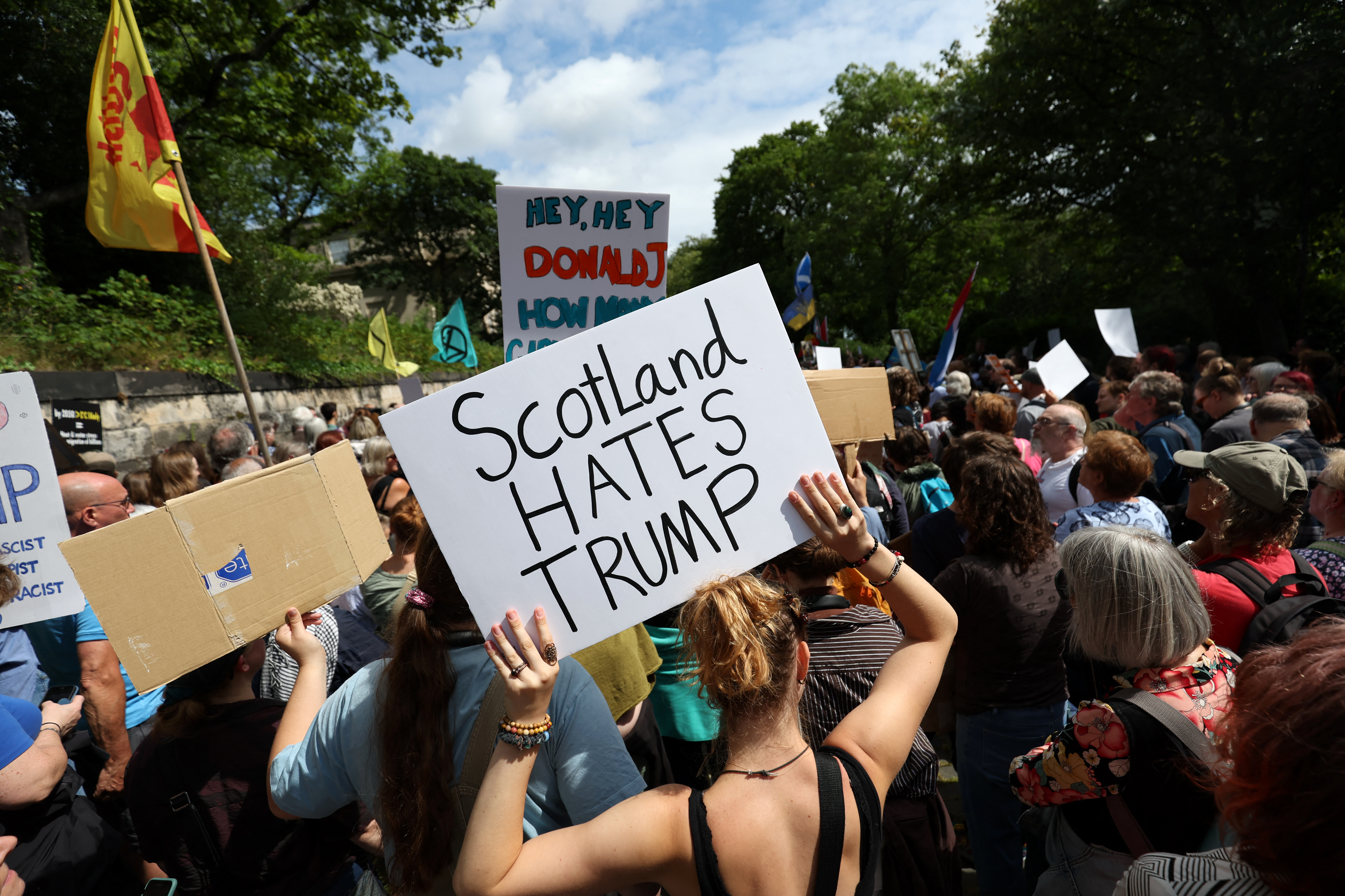 Demonstrators hold placards during a 'Stop Trump Coalition' protest near the US Consulate building in Edinburgh, Scotland