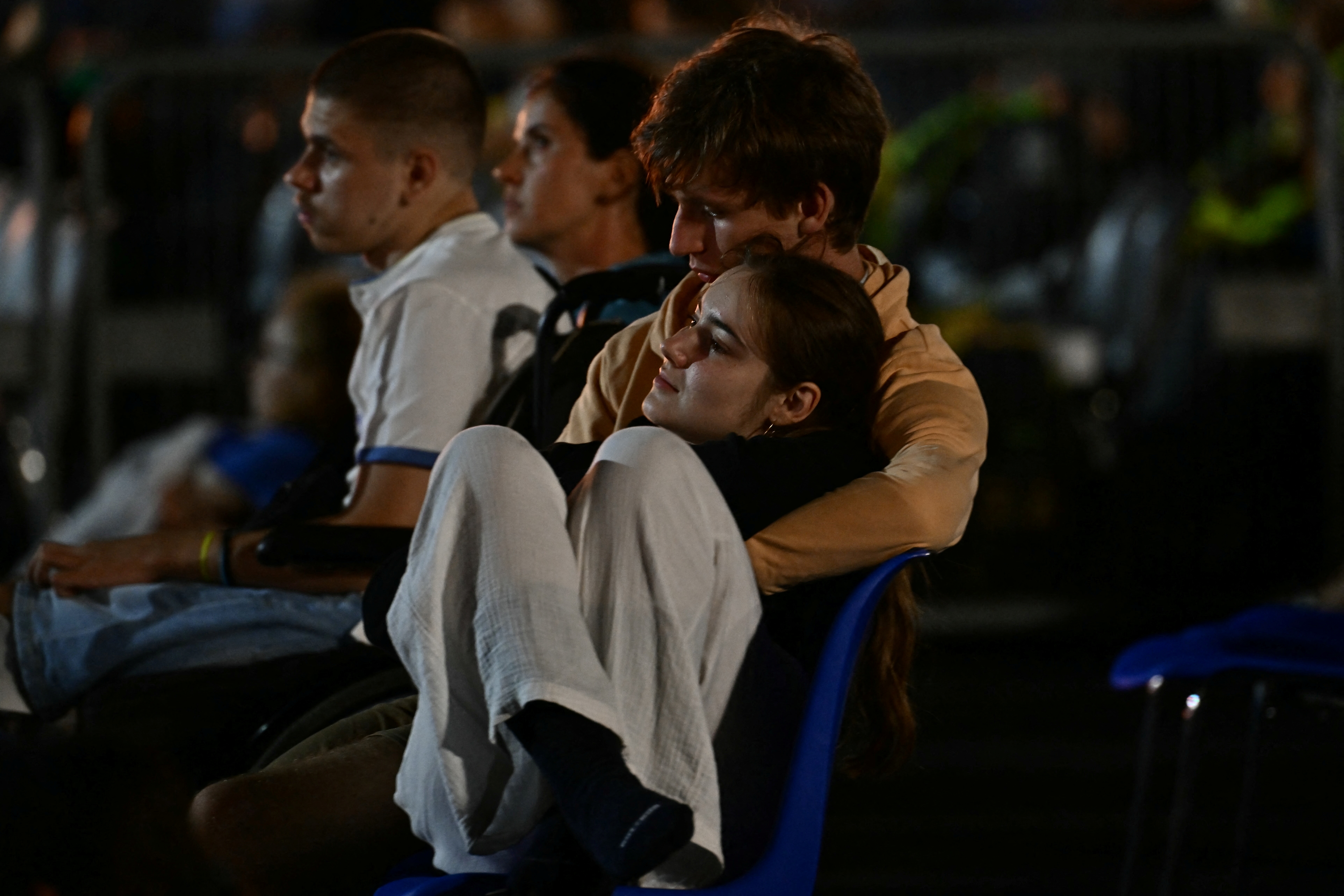 A young couple attends a prayer vigil led by Pope Leo XIV before Sunday Mass