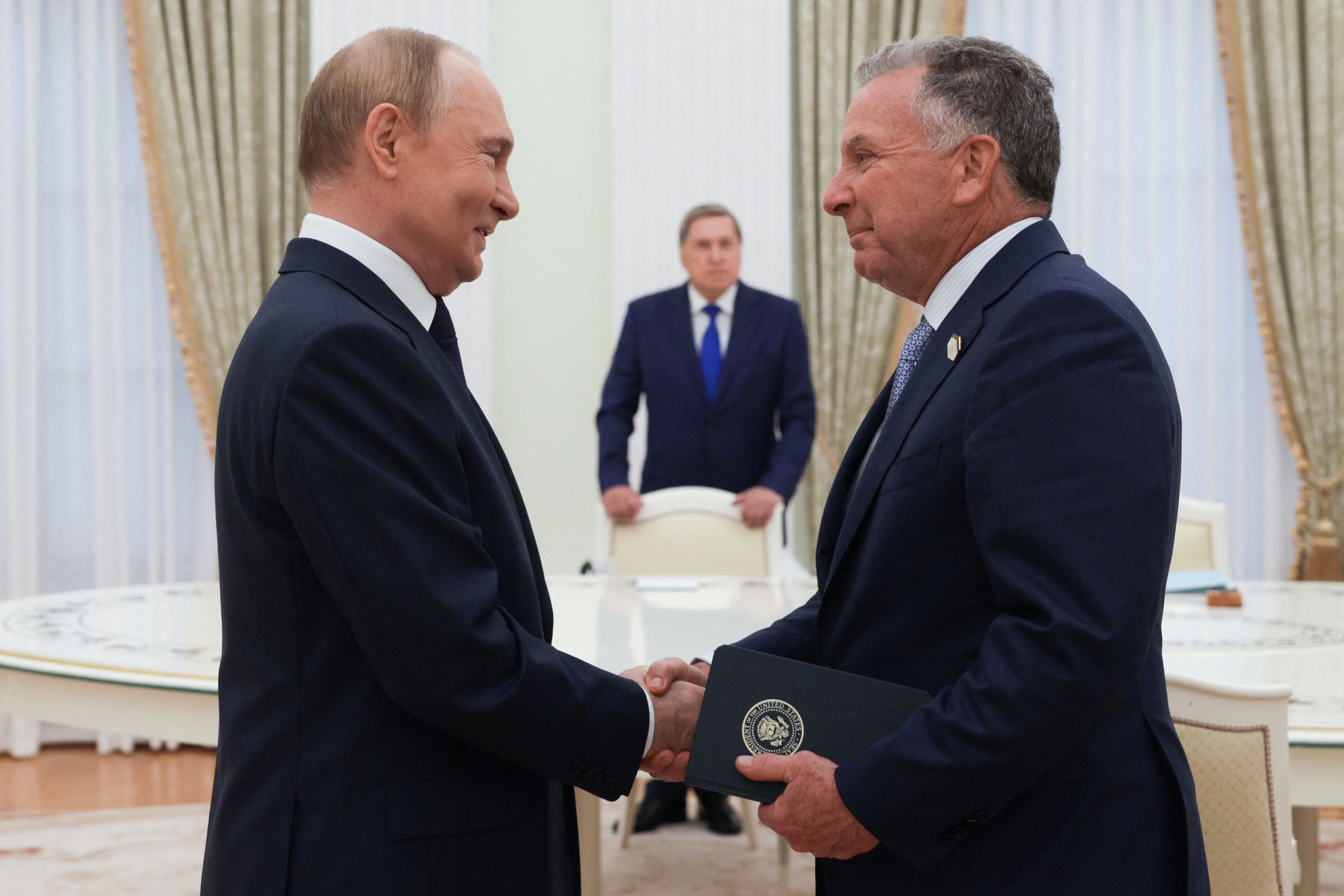 In this pool photograph distributed by the Russian state agency Sputnik, Russia's President Vladimir Putin greets US Special Envoy Steve Witkoff
