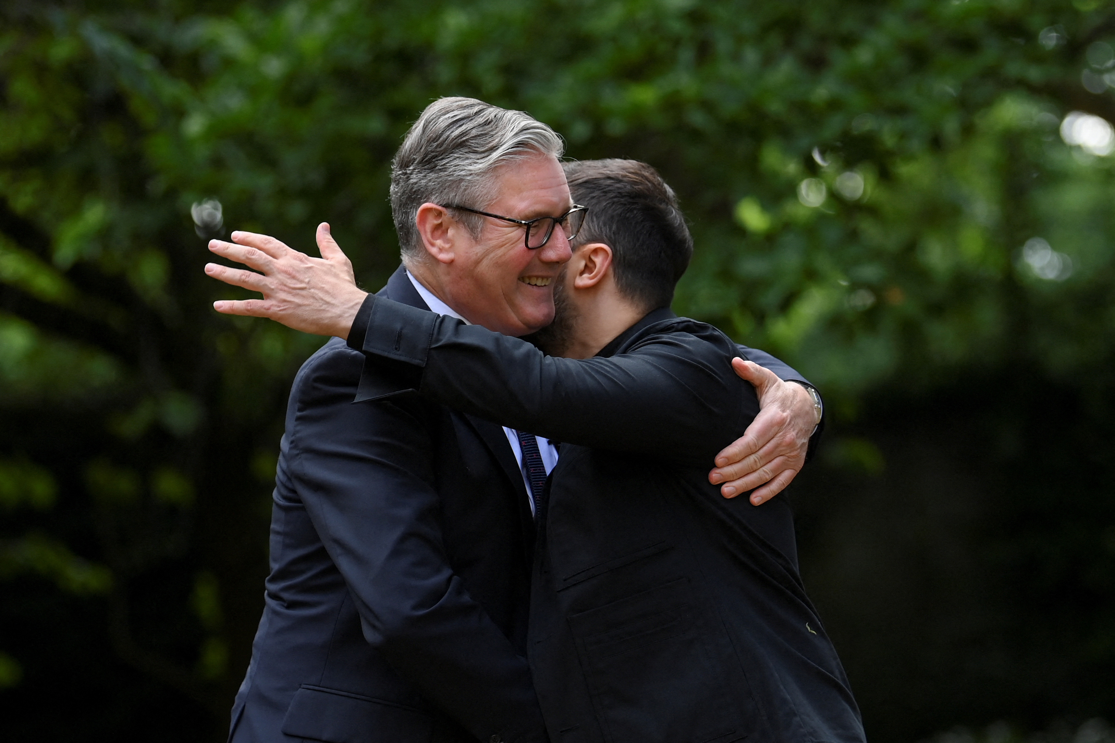 Britain's Prime Minister Keir Starmer hugs Ukraine's President Volodymyr Zelensky at 10 Downing Street, central London, on June 23, 2025 for a bilateral meeting on the eve of the NATO Summit. (Photo by Jaimi Joy / POOL / AFP)