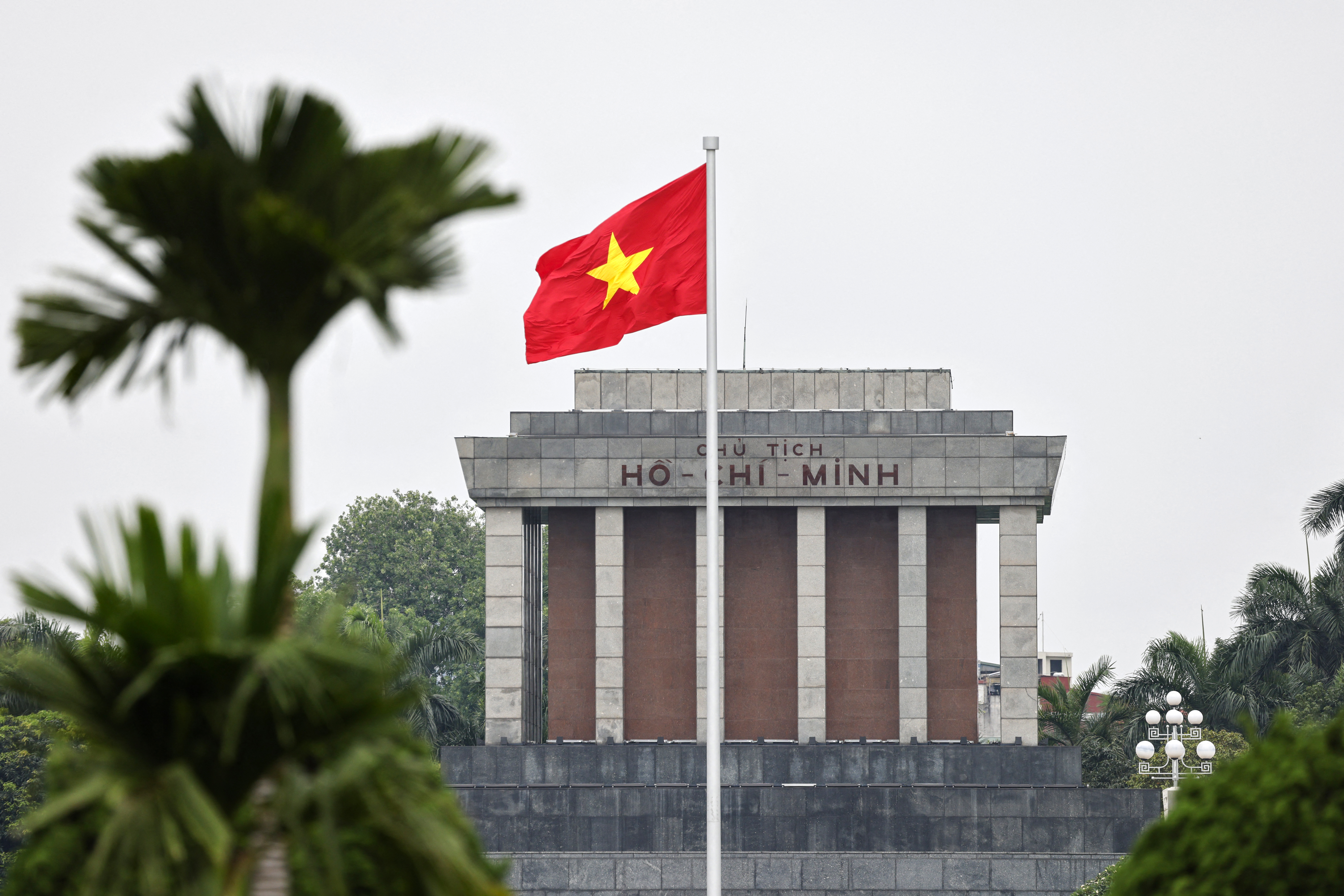 This picture shows a Vietnam's flag fluttering in front of the Ho Chi Minh Mausoleum ahead of a wreath-laying and tribute-paying ceremony with France's President Emmanuel Macron in Hanoi on May 26, 2025. (Photo by