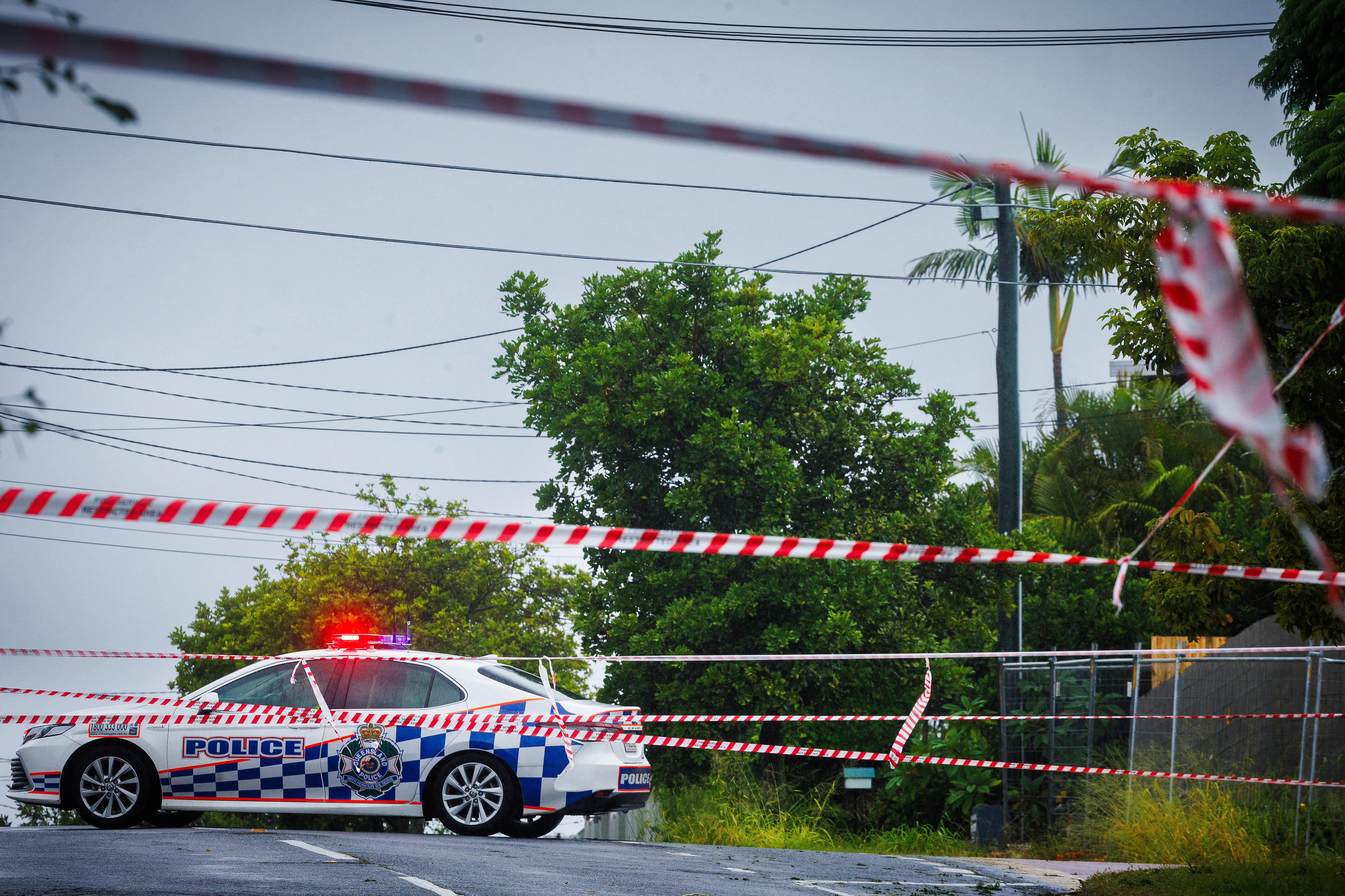 Police cordons are displayed to stop traffic after power lineshed the rain and wind-lashed eastern coast of Australia.