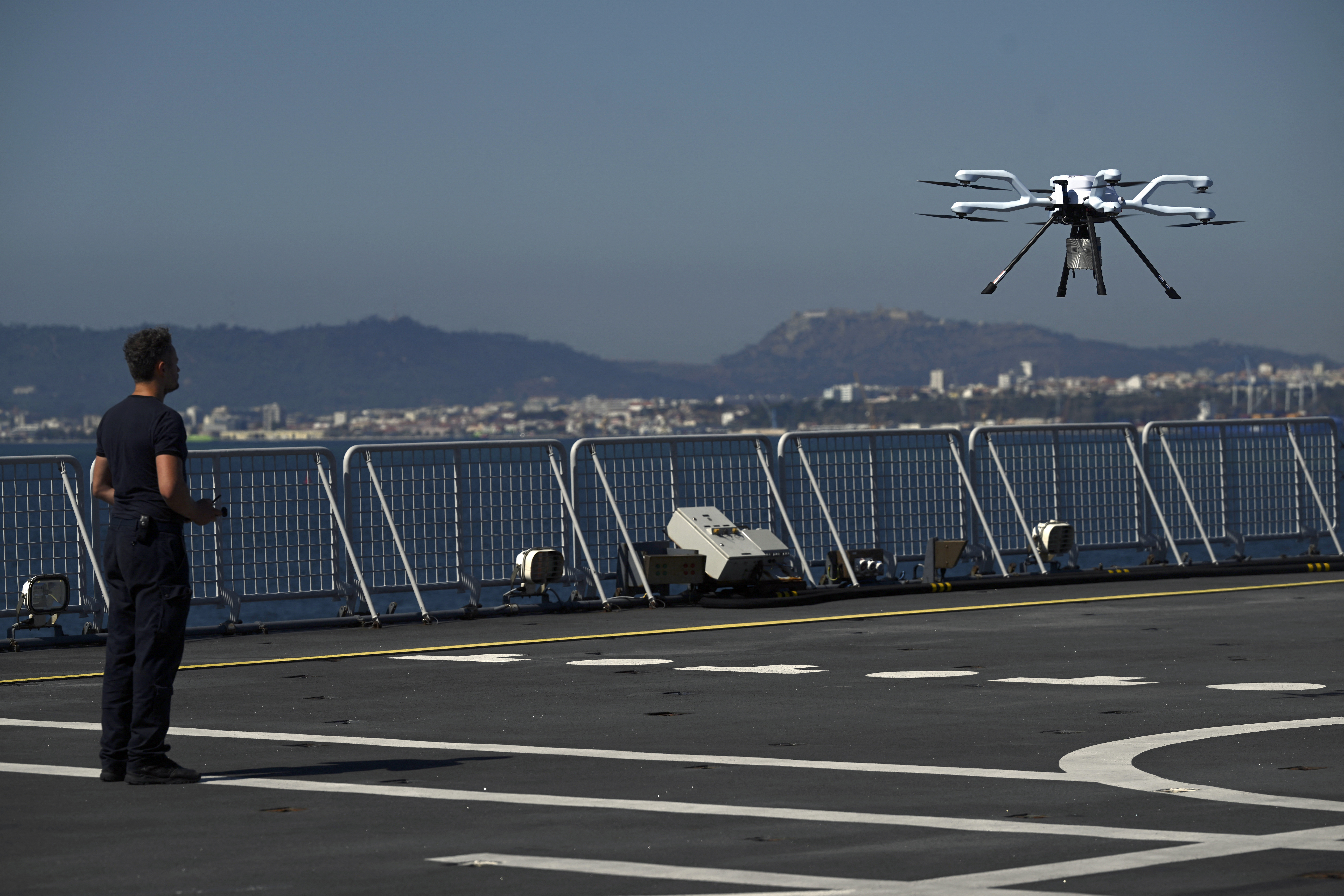 A soldier operates an Acecore remotely operated aerial vehicle at the landing platform dock of the Dutch amphibious transport warfare ship