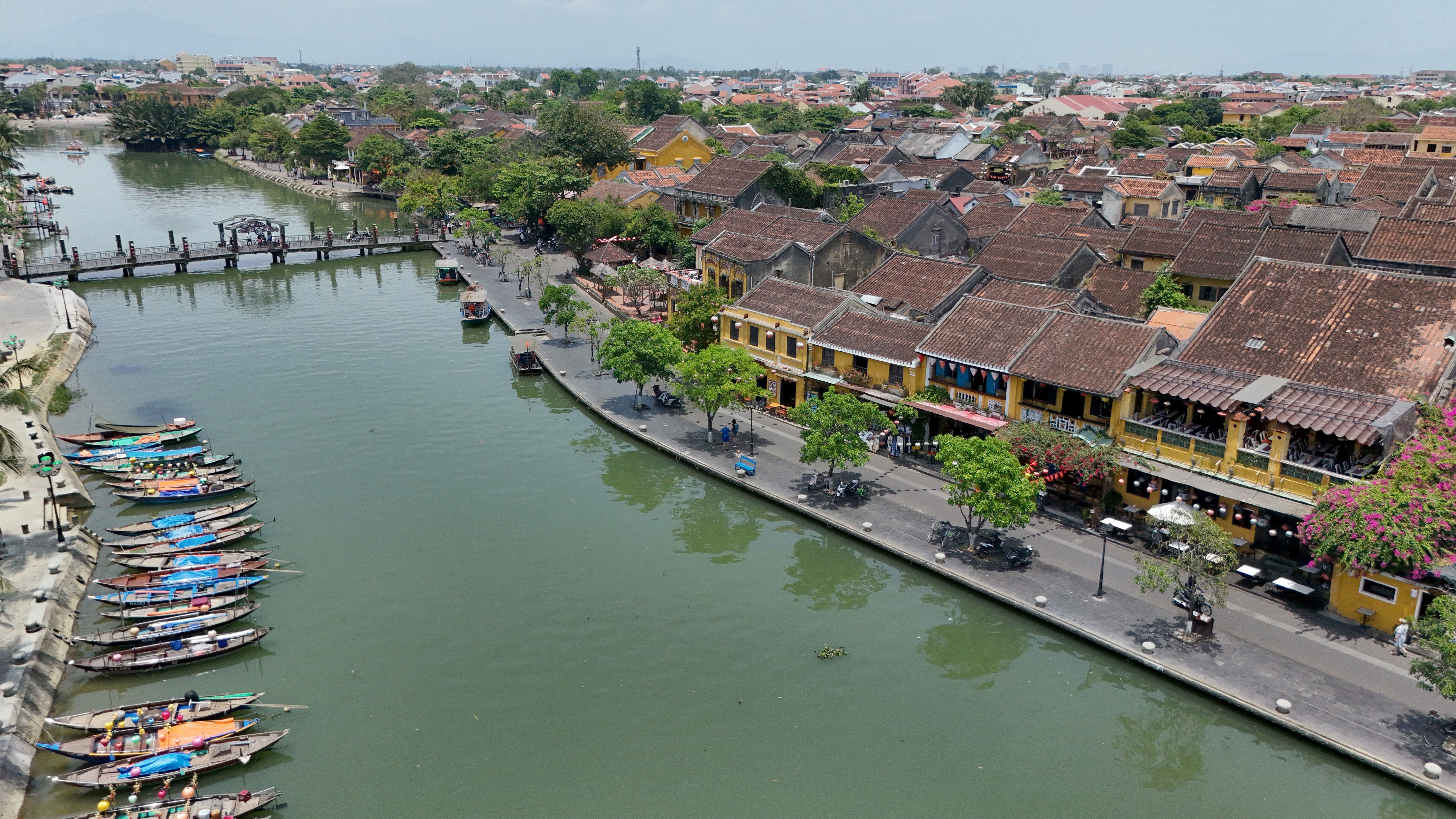 An aerial view shows the Hoai river in the ancient city of Hoi An, in Quang Nam province on April 12, 2025. Hoi An, a UNESCO world heritage site, is popular among both local and foreign tourists. (Photo by Nhac NGUYEN / AFP)