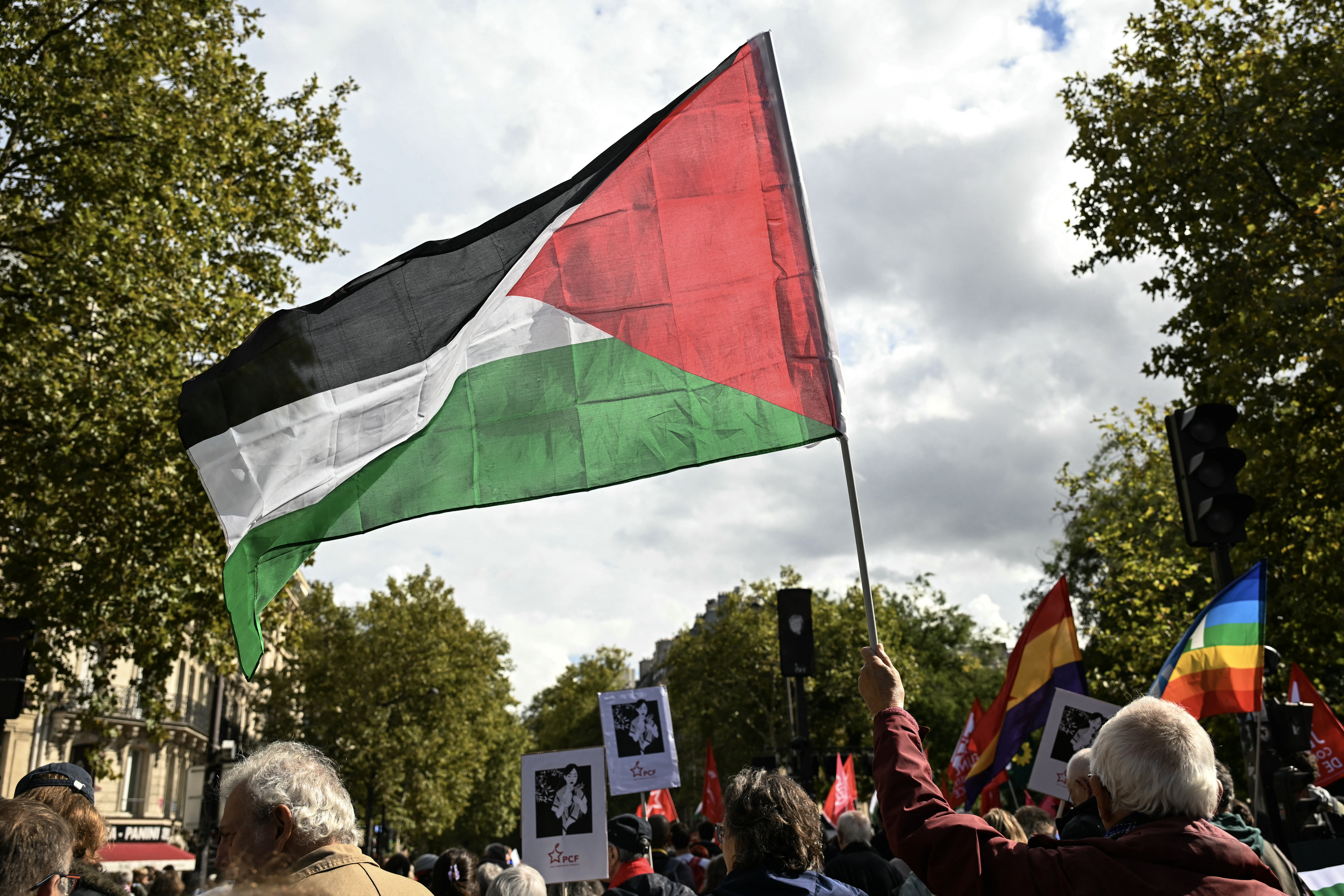 A protester waves a Palestinian flag during a march asking for the "recognition of the State of Palestine and the end of the genocide", in Paris on September 21, 2025.