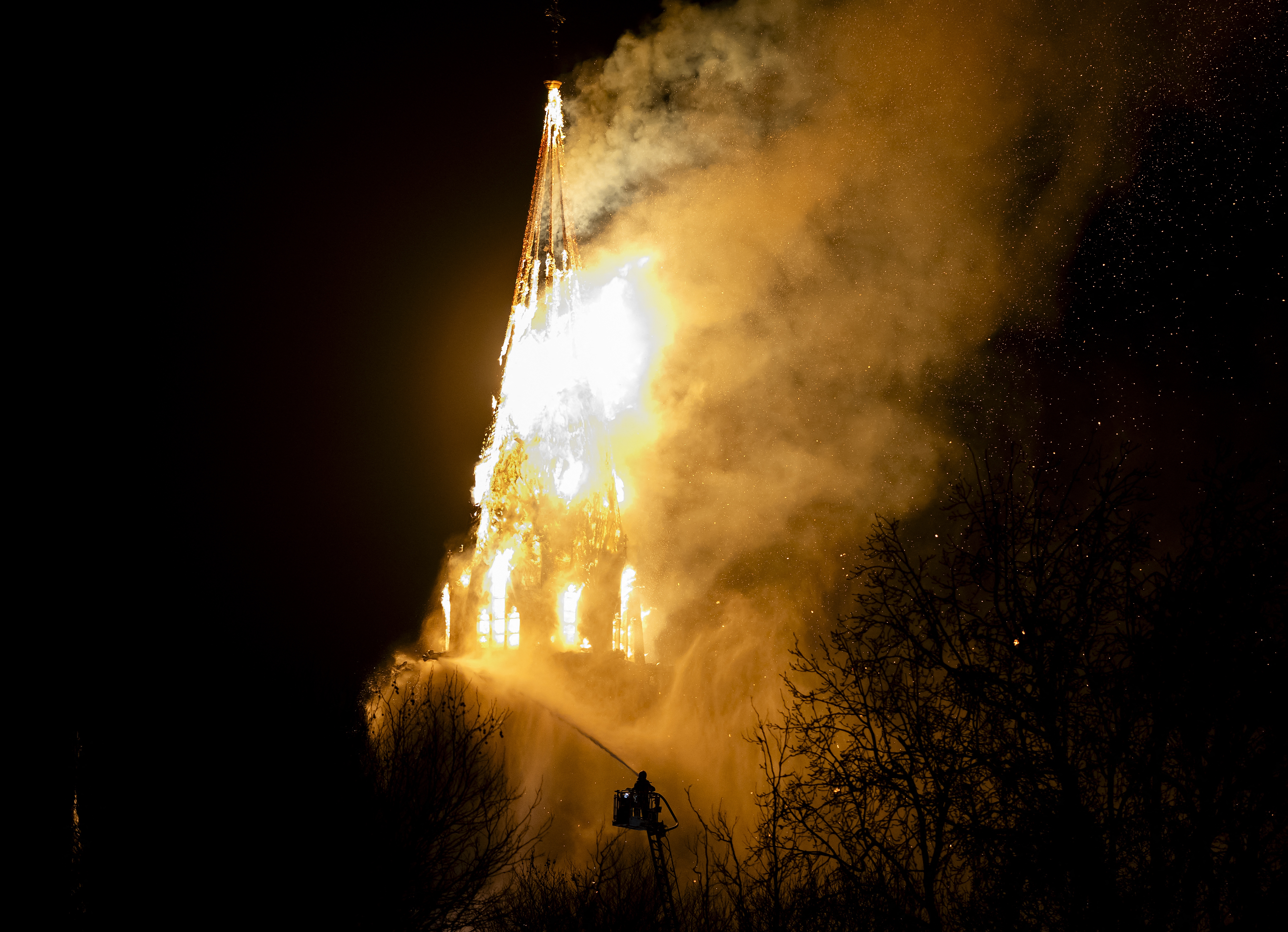 A fire tears through the Vondelkerk church tower in Amsterdam on New Year's eve, on January 1, 2026. (Photo by Remko DE WAAL / ANP / AFP) / Netherlands OUT