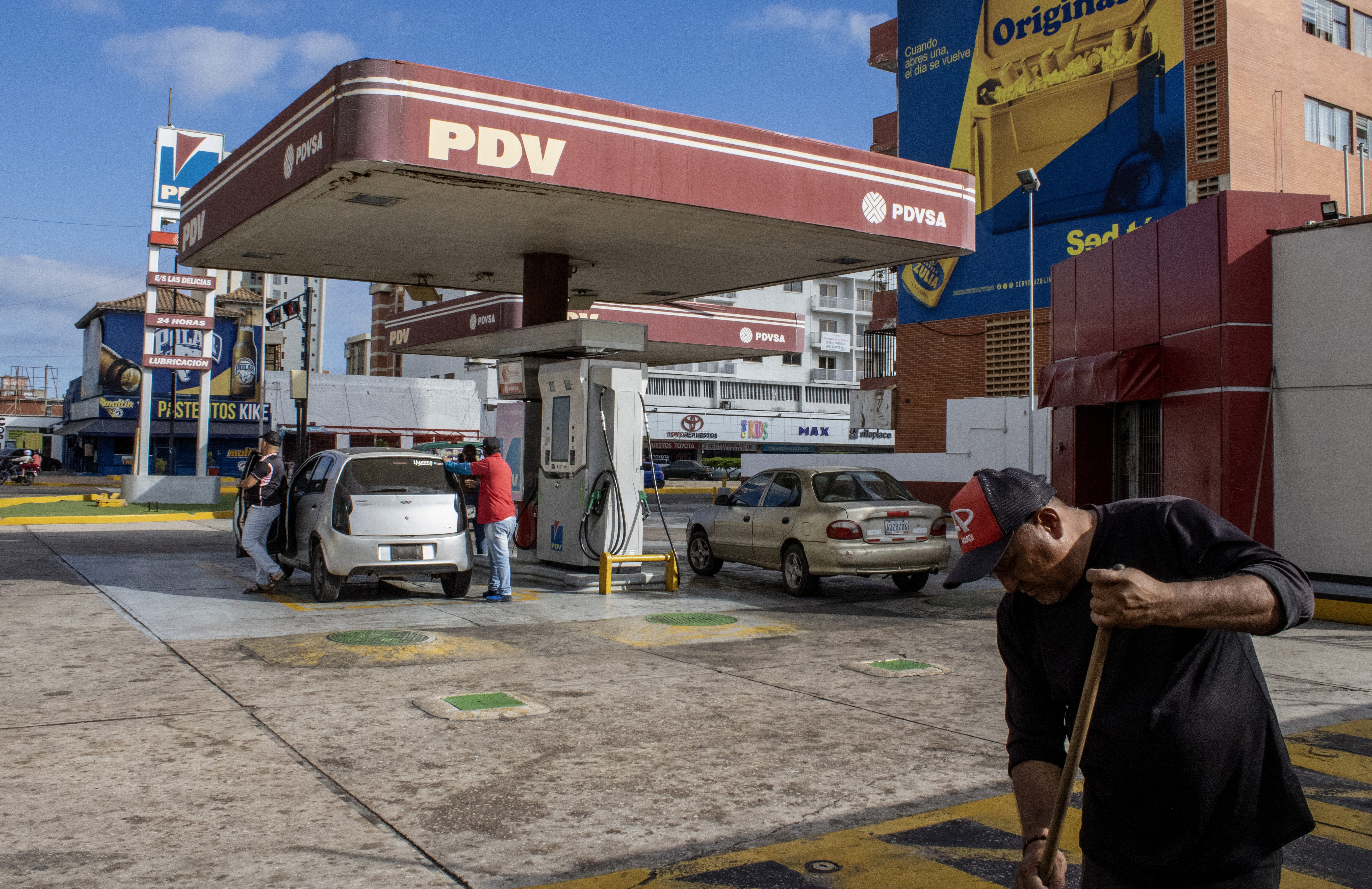A worker sweeps around a gas station in Maracaibo, Venezuela, on January 7, 2026. US Energy Secretary Chris Wright said in January 7, Washington will control sales of Venezuelan oil "indefinitely,"