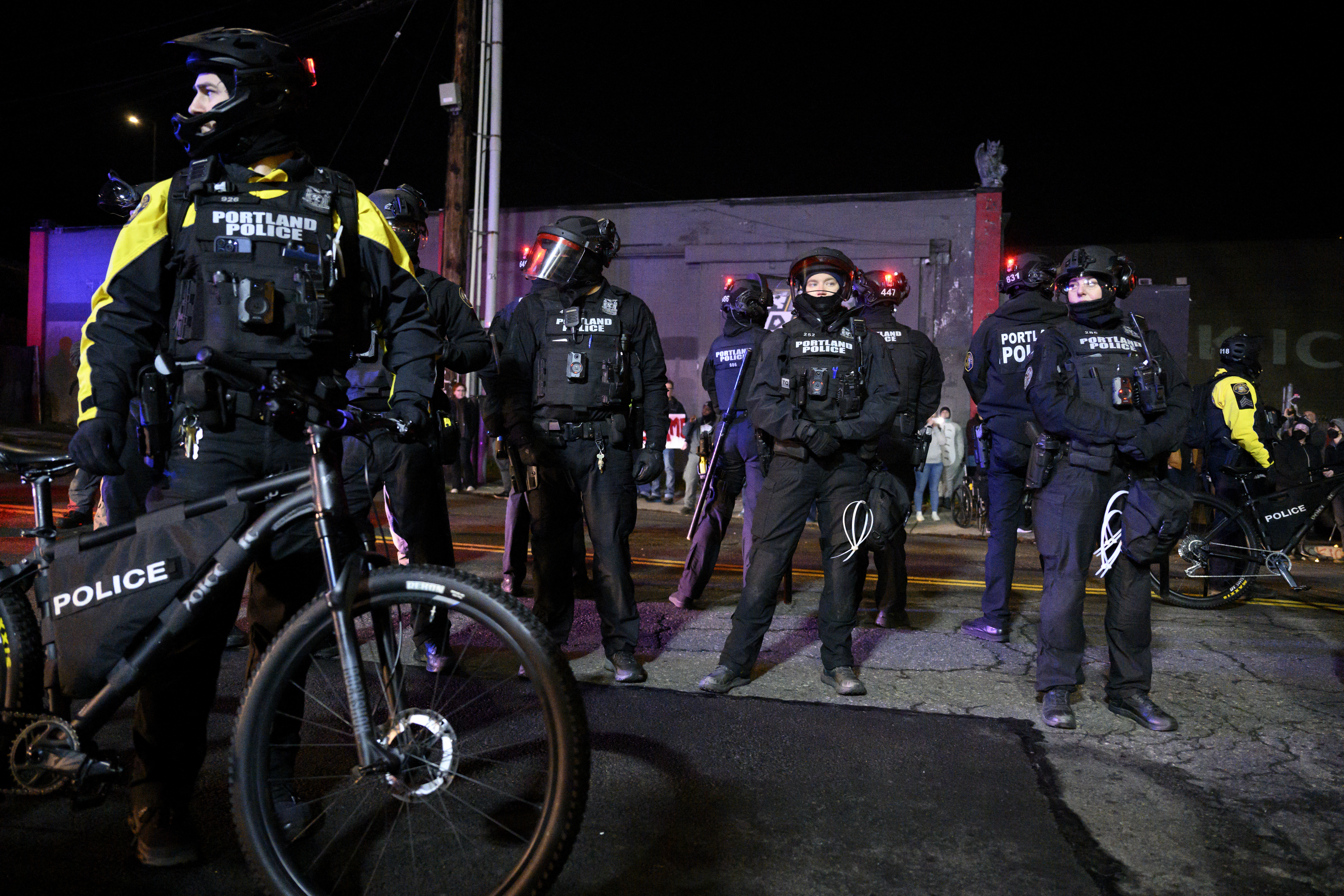 PORTLAND, OREGON - JANUARY 10: Portland police officers dawning riot gear arrive at an anti-ICE protest at the U.S. Immigration and Customs Enforcement (ICE) building