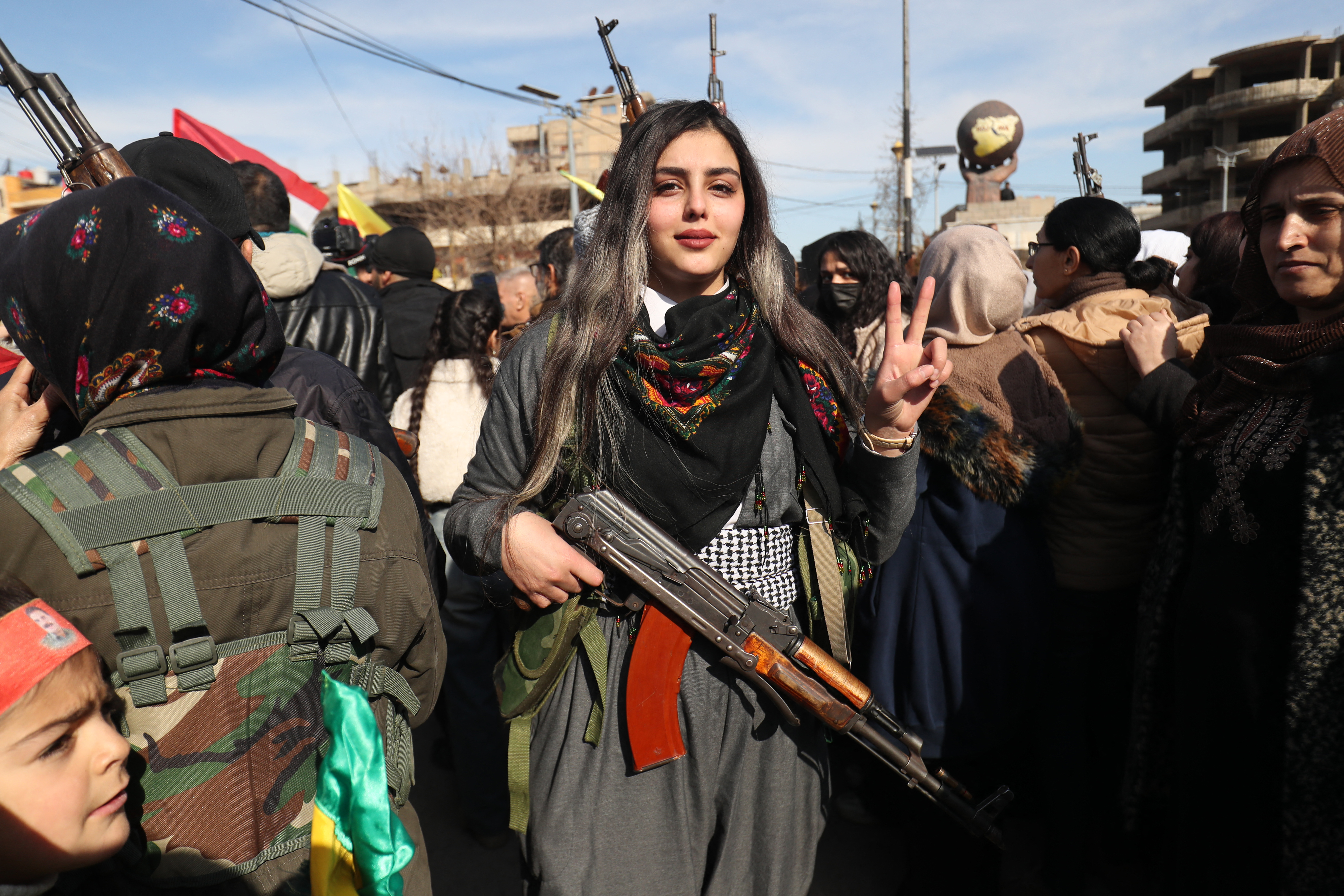 Kurdish civilians gather with their weapons in the city of Qamishli on January 20, 2026 as the Kurdish-led Syrian Democratic Forces (SDF) called for "young Kurds, men and women" both within and outside Syria to "join the ranks of the resistance".