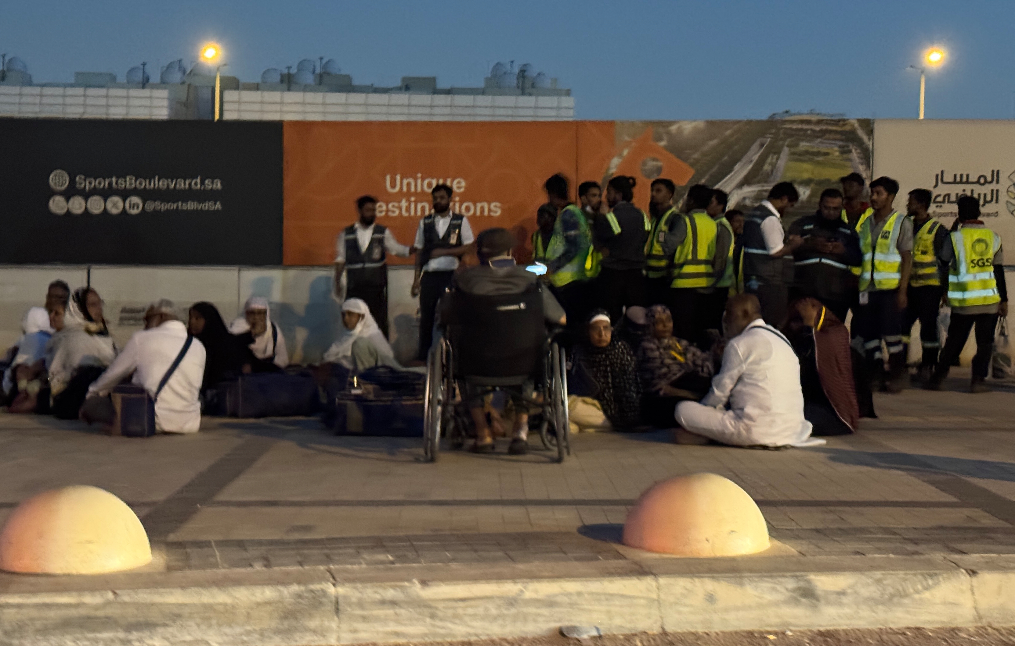 People gather outside a metro station on the road to King Khalid International Airport in Riyadh, Saudi Arabia, Saturday, Oct. 10, 2026. (AP Photo)
