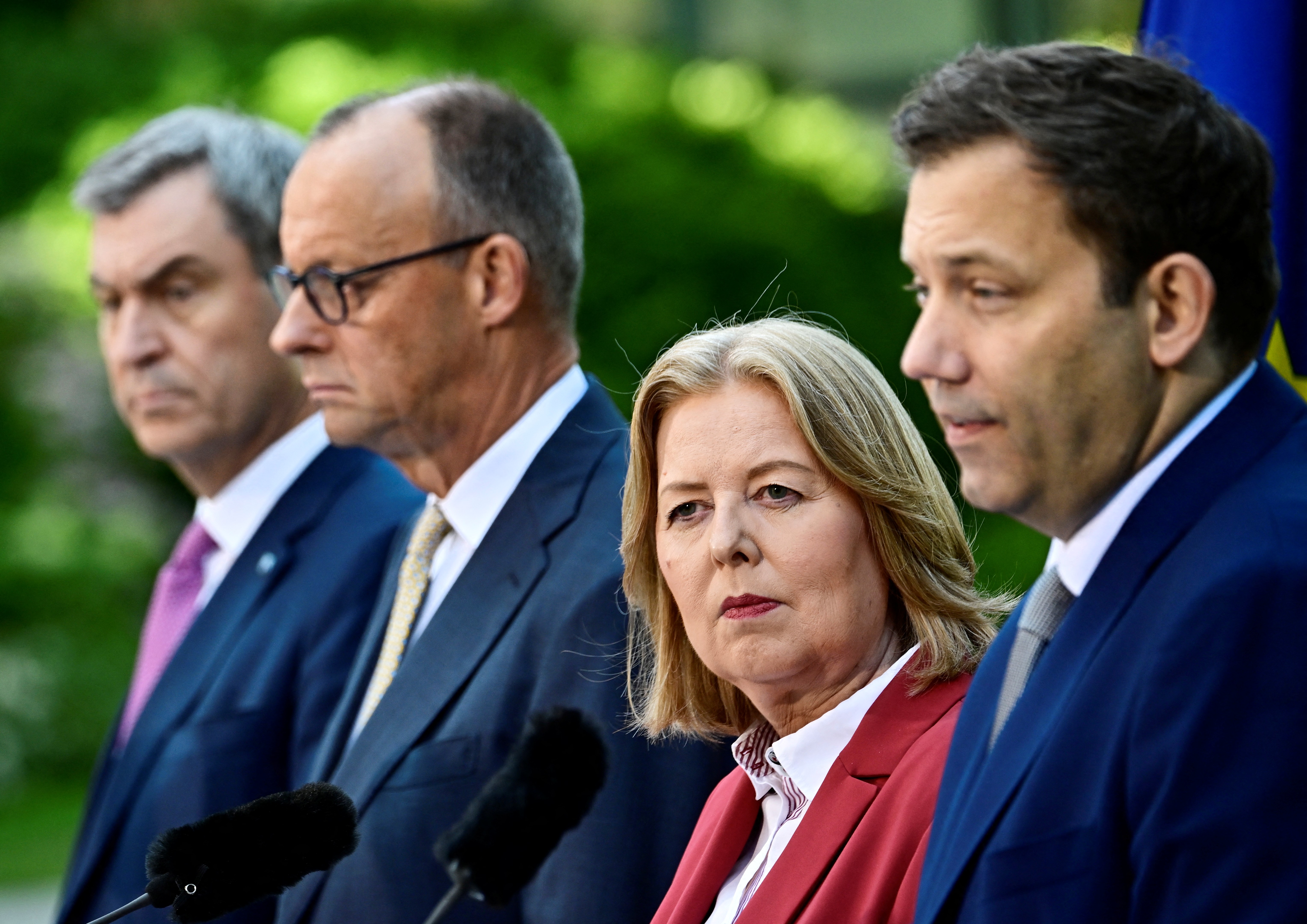 (FILES) (L-R) Bavaria's State Premier and leader of the conservative Christian Social Union (CSU) Markus Soeder, German Chancellor Friedrich Merz (CDU), German Minister for Labour and Social Affairs Baerbel Bas (SPD) and German Finance Minister