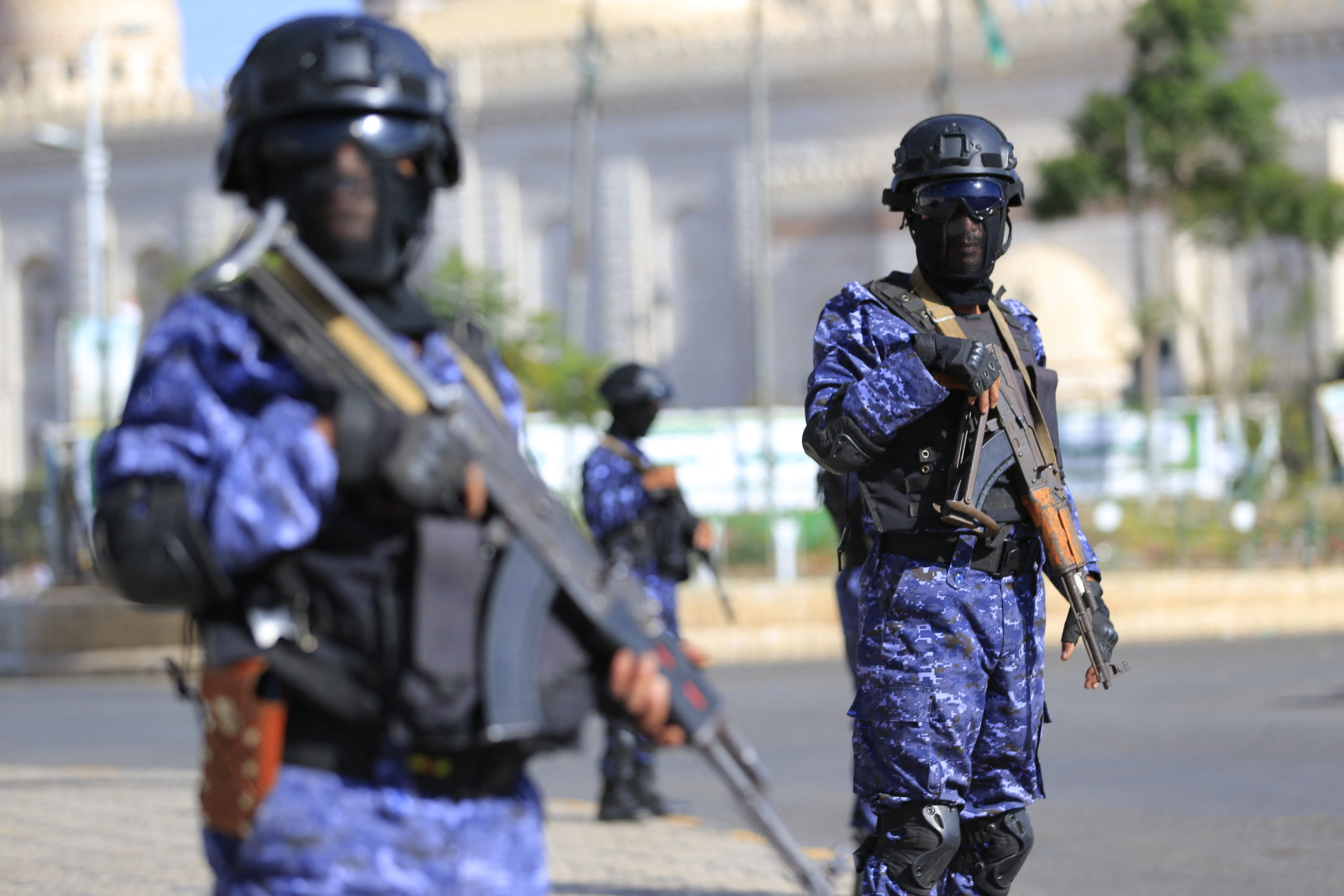 Security force members stand guard during a protest against Saudi intervention in Yemen, in Sanaa on October 9, 2026.