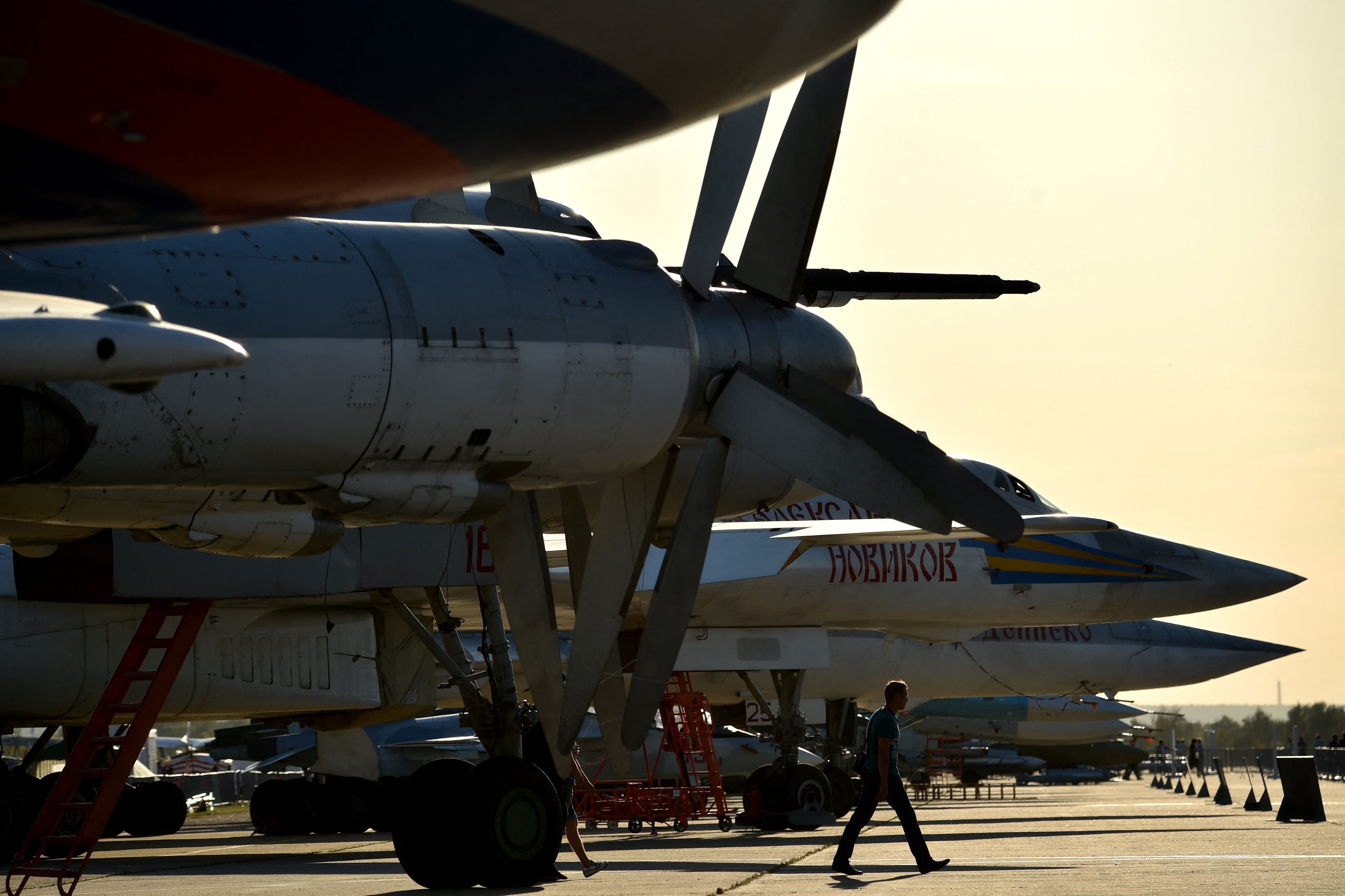 A man walks close to a Tupolev TU-95MS turboprop-powered strategic bomber during the MAKS-2015, the International Aviation and Space Show, in Zhukovsky, outside Moscow, on August 25, 2015. AFP PHOTO / KIRILL KUDRYAVTSEV (Photo by KIRILL KUDRYAVTSEV / AFP)