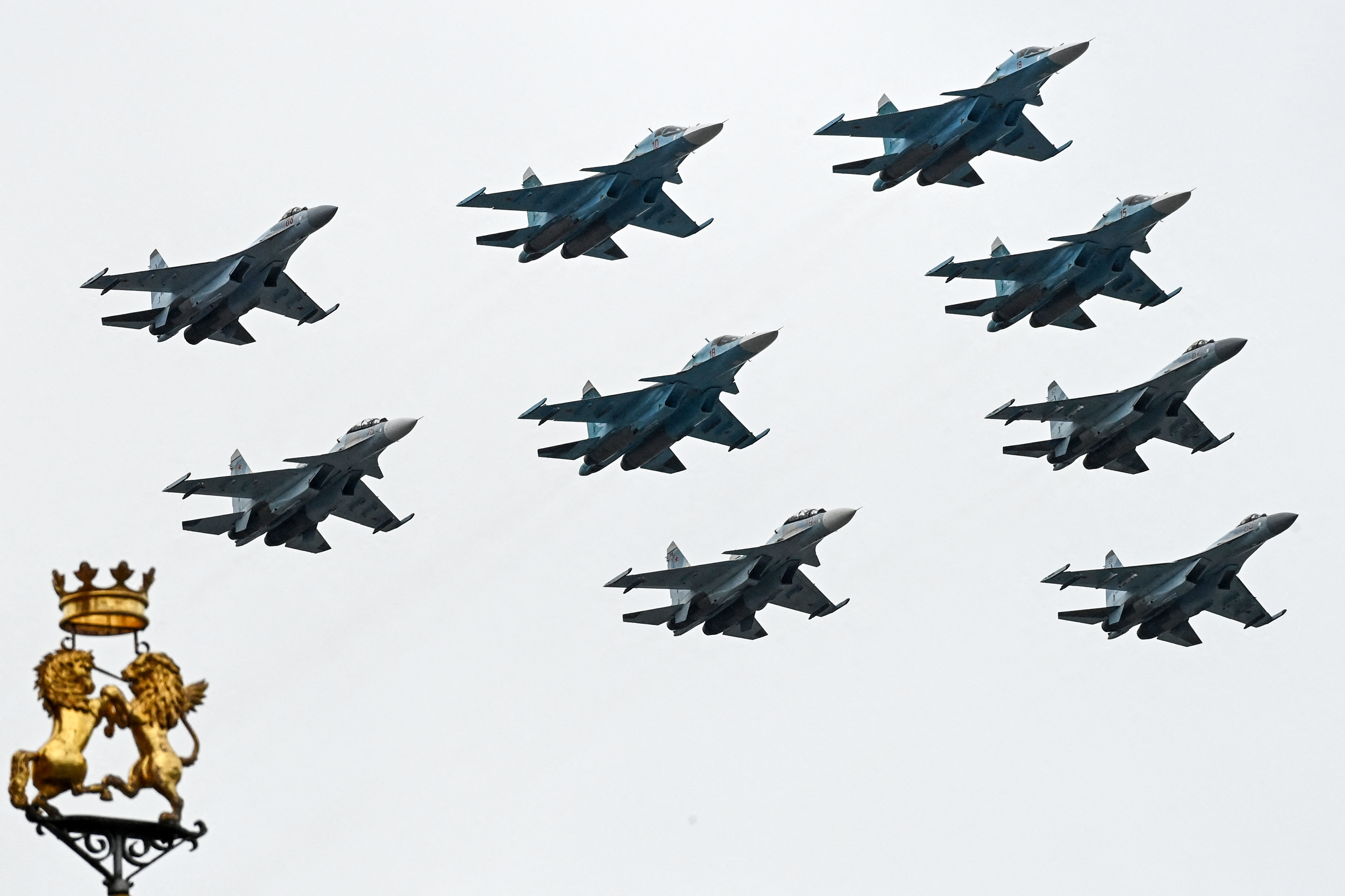 Russian Sukhoi Su-35S fighter aircrafts, Su-34 military fighter jets and Su-30SM jet fighters fly in formation over central Moscow during the Victory Day military parade on May 9, 2021.