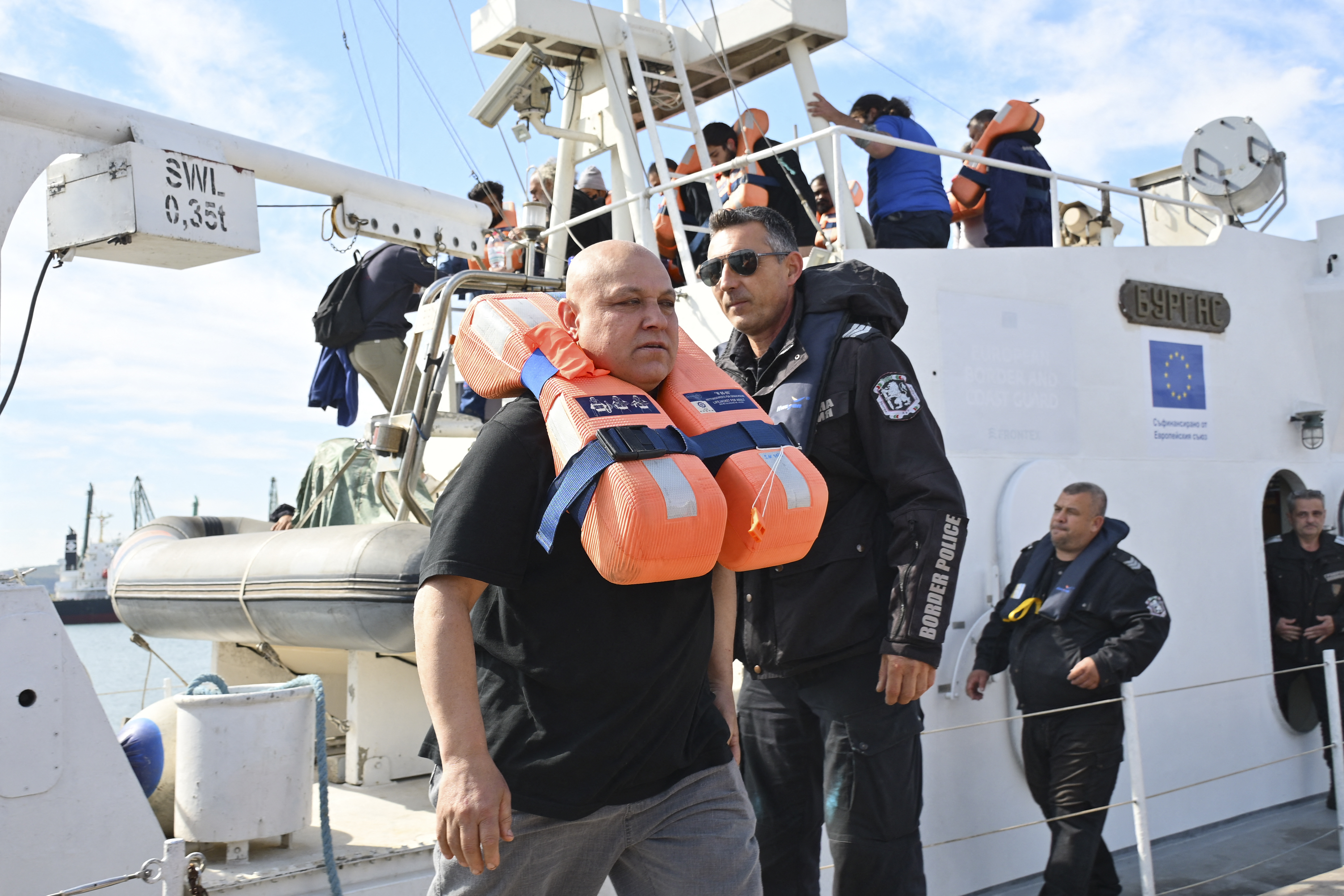 Crew members from a vessel struck by drones in Bulgaria's exclusive economic zone arrive at the port of Varna after being rescued on October 6, 2026.