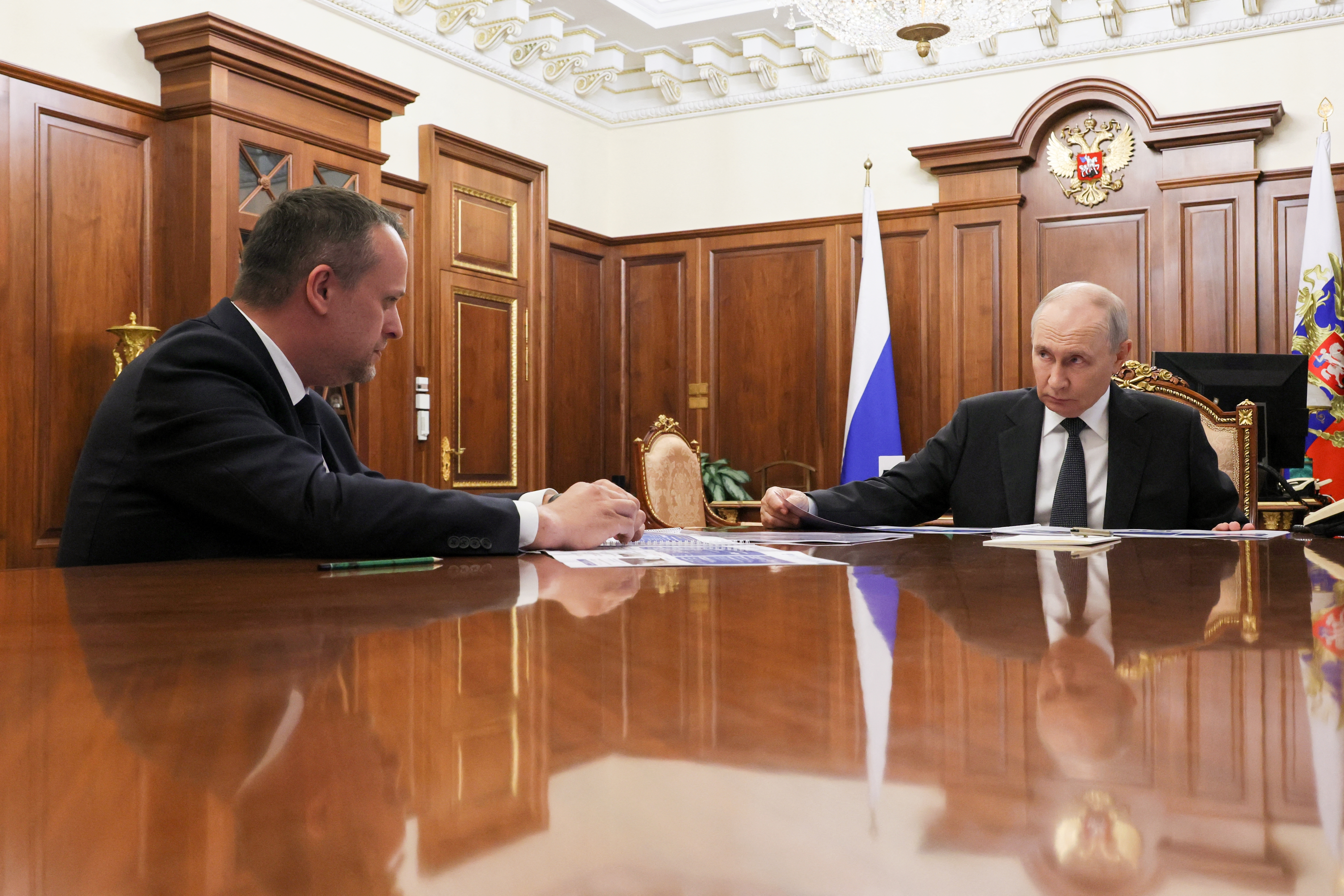 In this pool photograph distributed by the Russian state agency Sputnik, Russia's President Vladimir Putin meets with Russian Minister of Transport Andrey Nikitin in Moscow on October 13, 2026.
