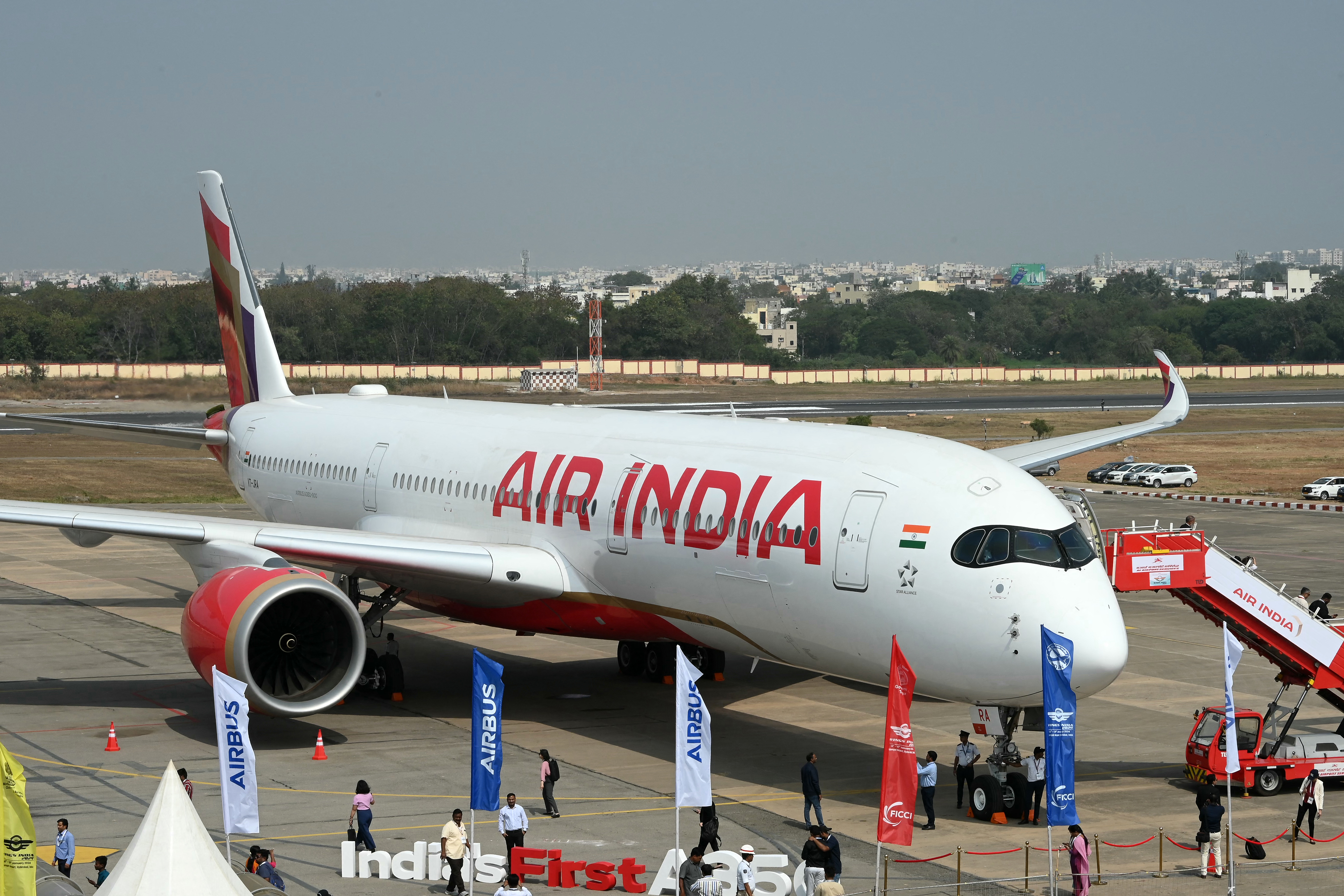 Visitors gathered near India's first Airbus A350 of Air India airline during the 'Wings India 2024', an exhibition and conference on civil aviation, at the Begumpet Airport in Hyderabad on January 18, 2024. (Photo by NOAH SEELAM / AFP)