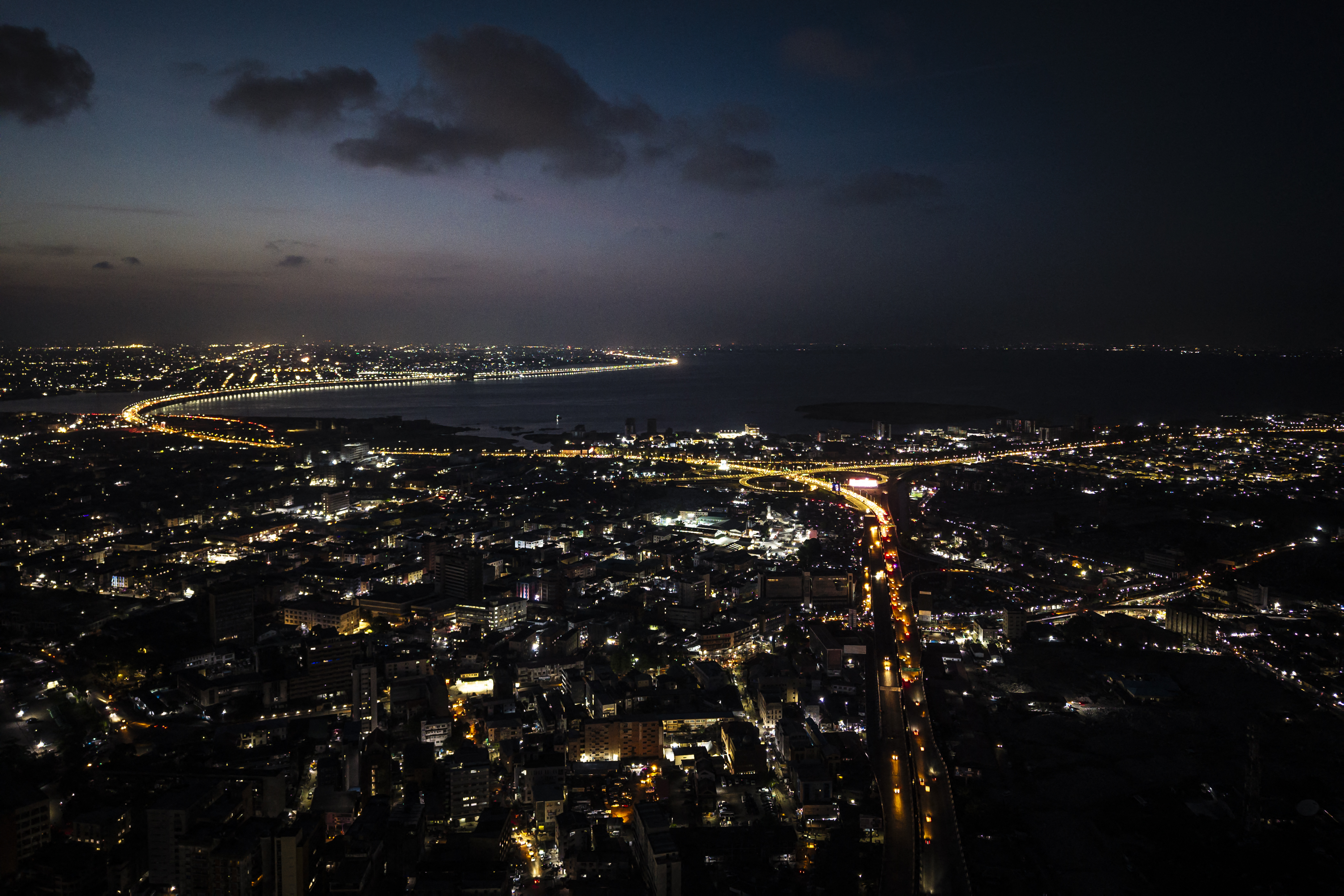 This aerial view shows Lagos Island and the Third Mainland bridge in the background at night in Lagos on May 14, 2025. (Photo by OLYMPIA DE MAISMONT / AFP)