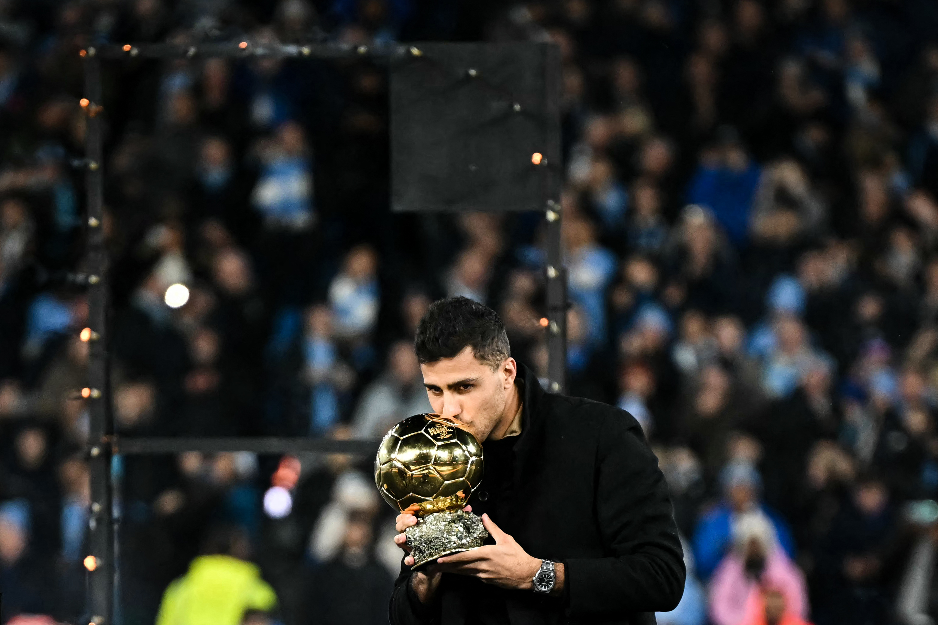 Manchester City's Spanish midfielder #16 Rodri kisses the 2024 Ballon d'Or award he received on October 28 during a presentation prior to the start of the English Premier League football match between Manchester City