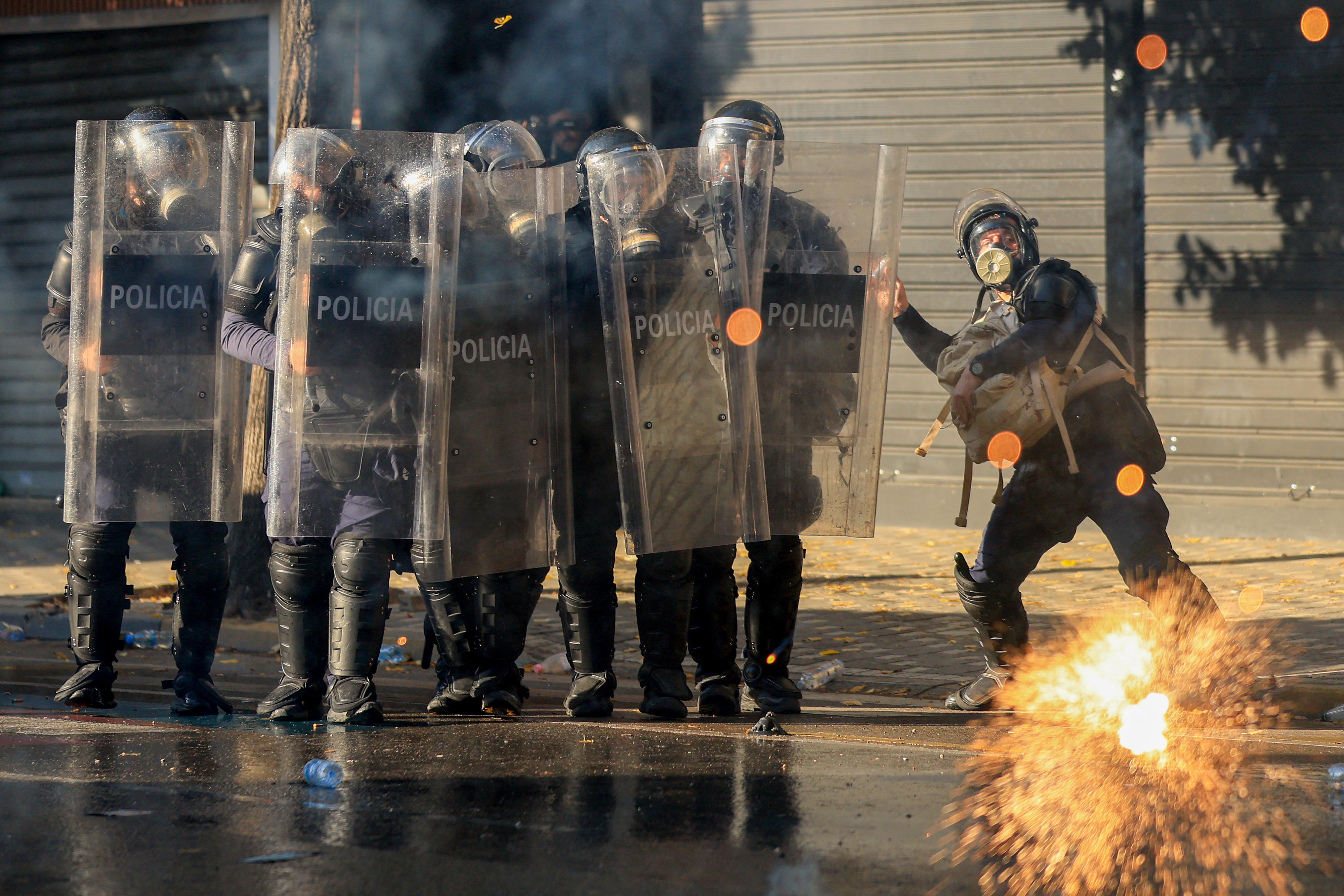 Albanian riot police officers gesture during an anti-government demonstration in central Tirana on October 20, 2026, after a week of violent anti-government protests.