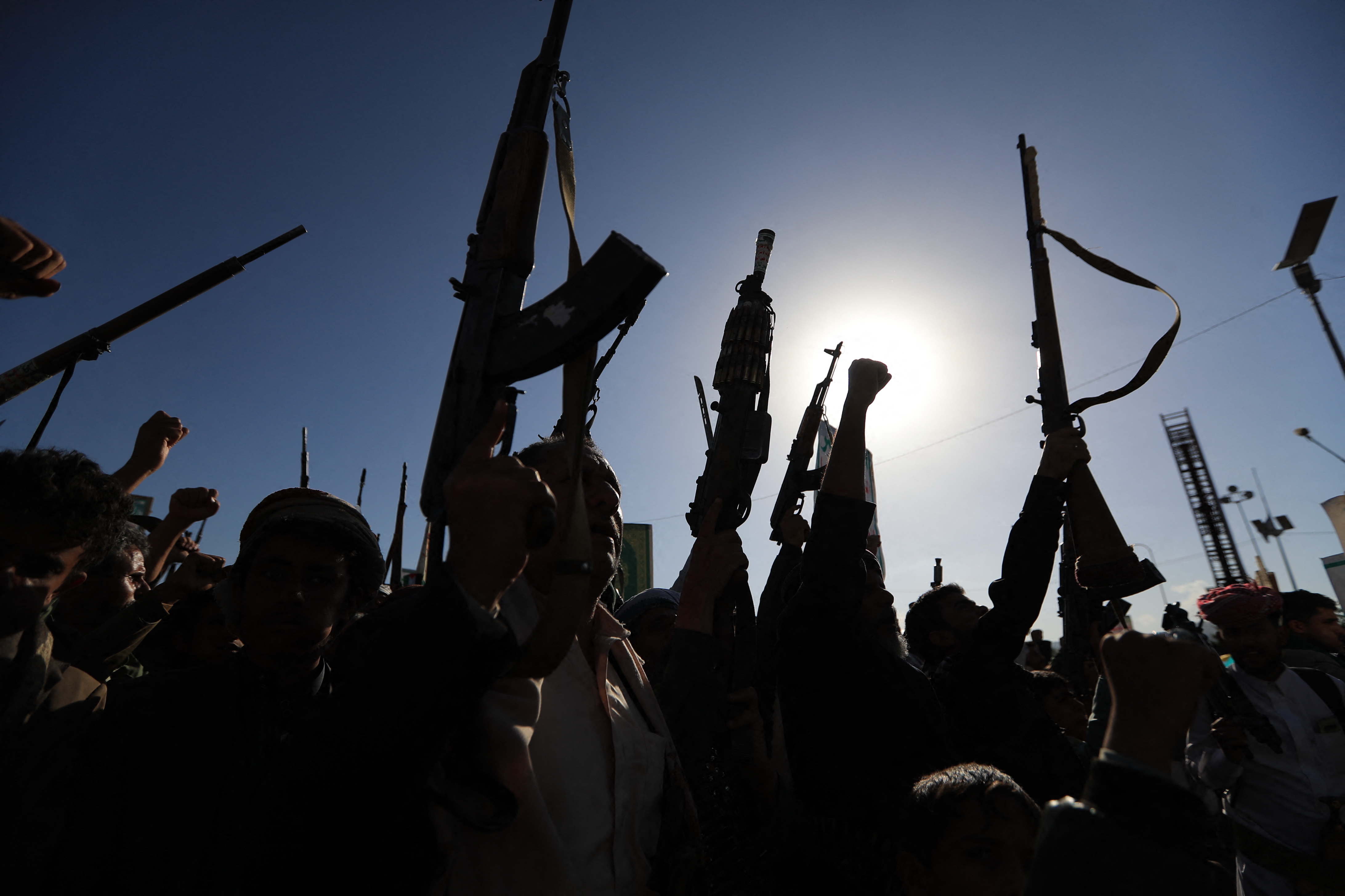 Supporters of the Houthi authorities brandish their weapons during a protest against Saudi intervention in Yemen, in Sanaa, on October 9, 2026.
