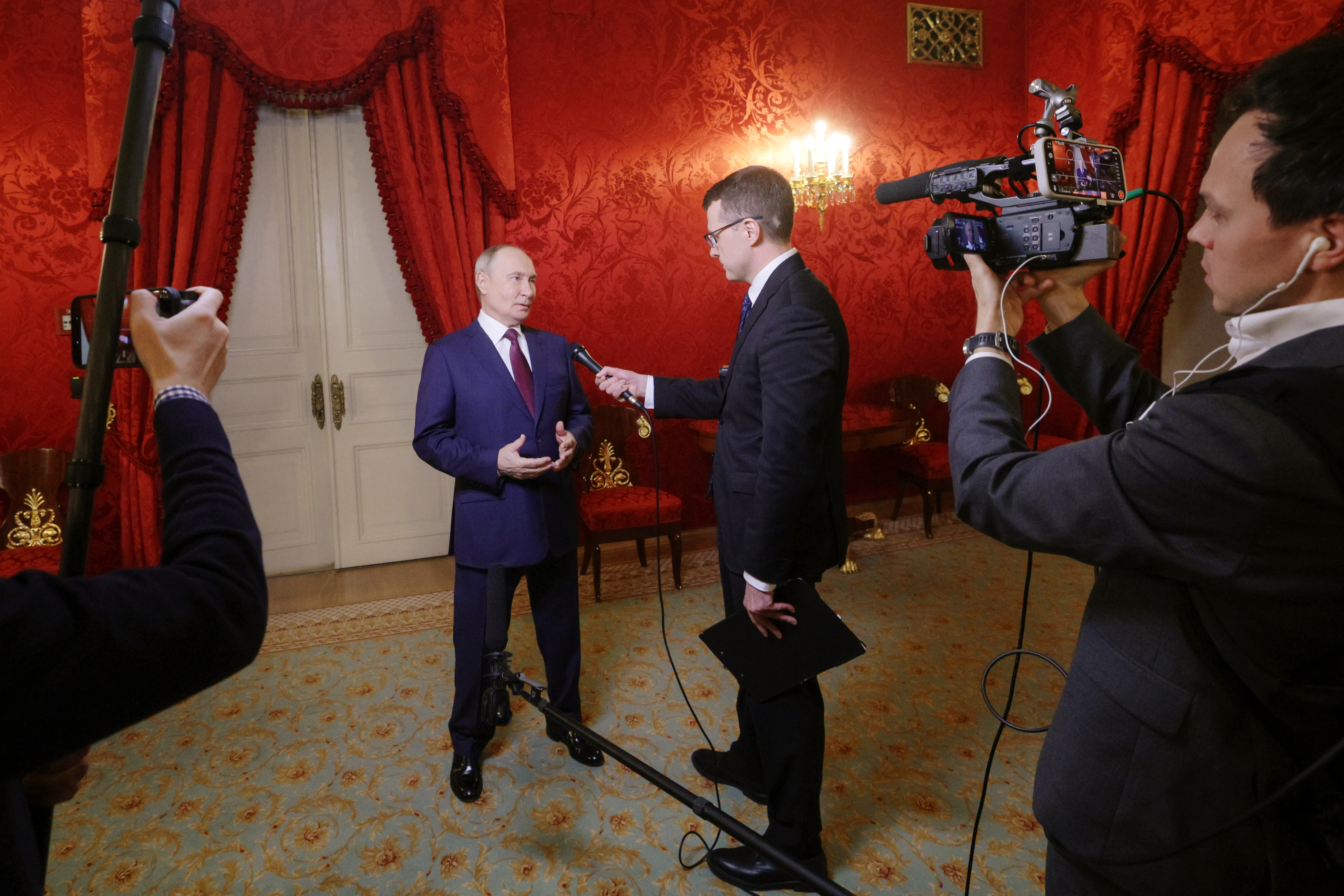Russian President Vladimir Putin, center left, answers questions from journalist Pavel Zarubin after attending a meeting on the occasion of the 150th anniversary of the Russian Theatre Union at the Bolshoi Theatre in Moscow