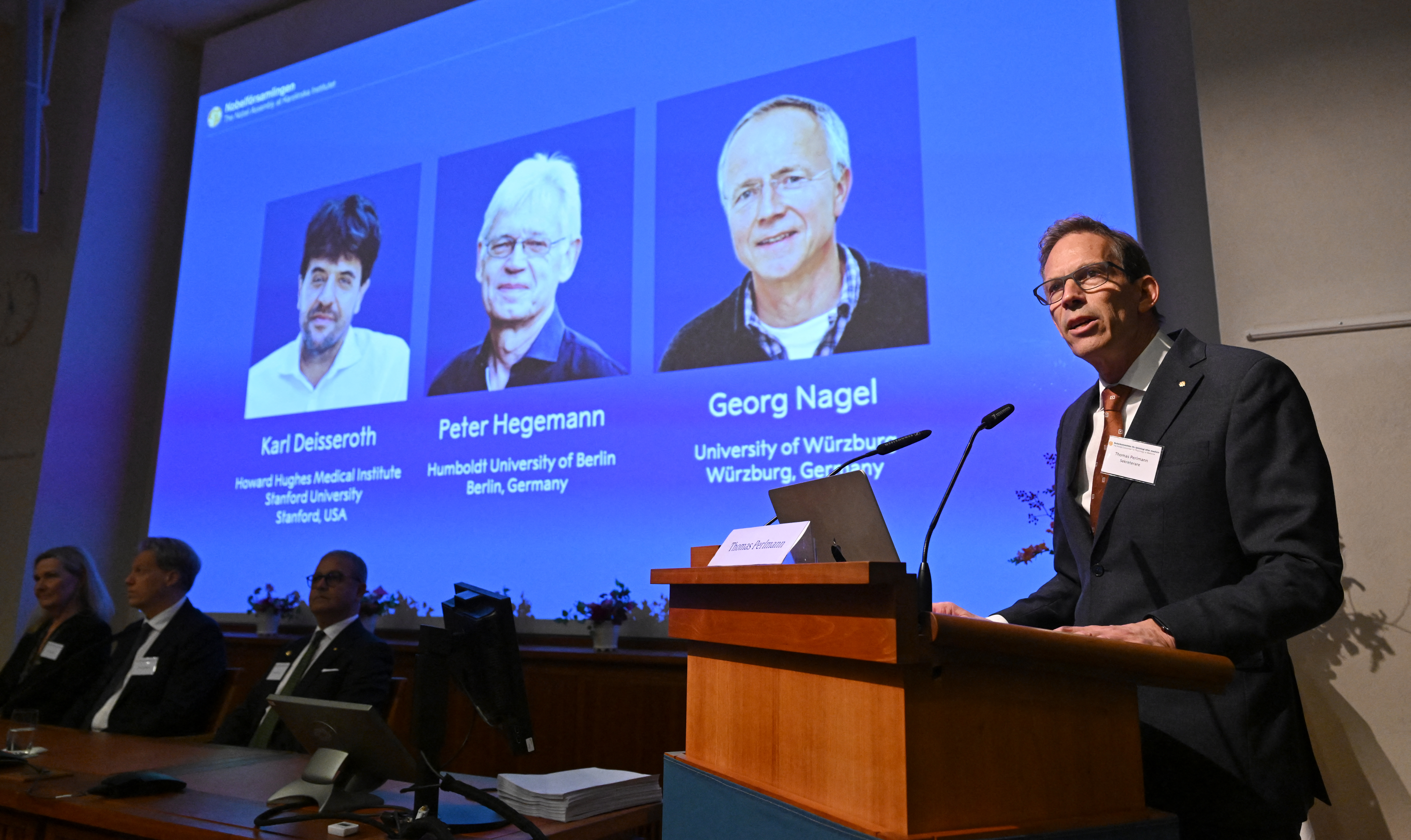 ames of this year's laureates (L-R) Karl Deisseroth, Peter Hegemann and Georg Nagel. (Photo by Jonathan Nackstrand / AFP)