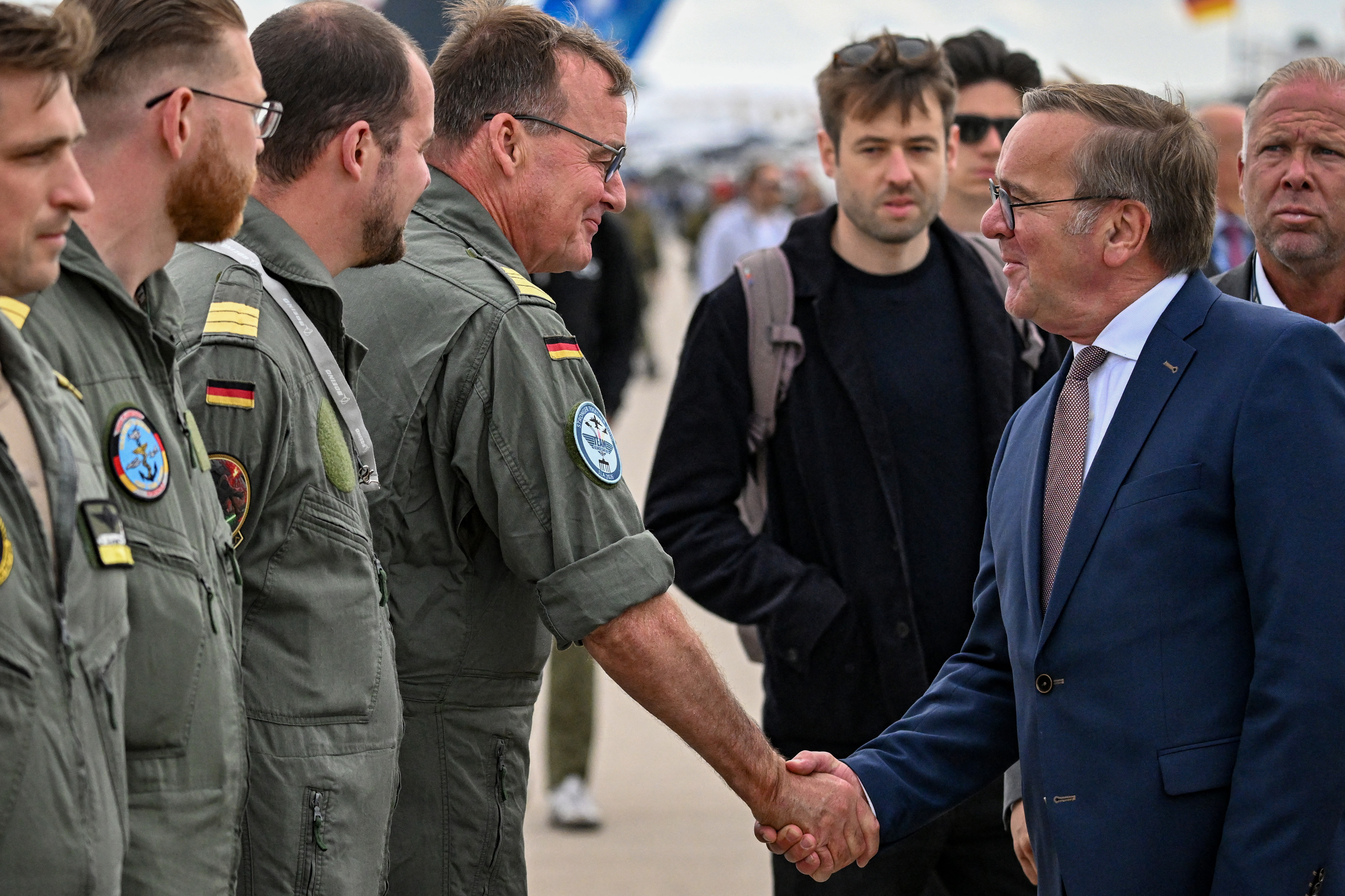 German Defence Minister Boris Pistorius greets the crew of the Boeing P-8 Poseidon aircraft as he tours the International Aerospace Exhibition (ILA) at the BER Airport in Schoenefeld, southeast of Berlin