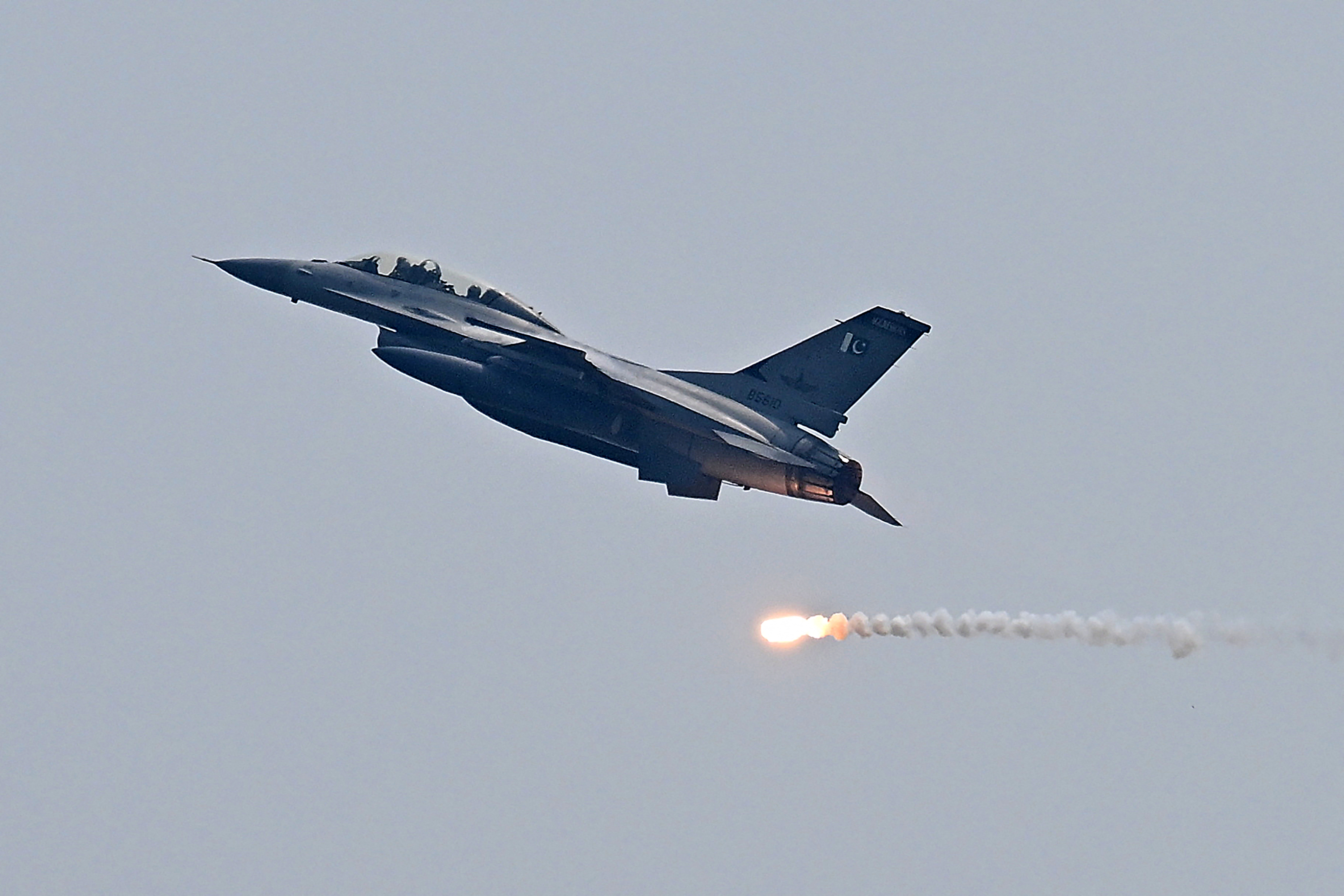 A Pakistan Air Force fighter jet drops flares during a rehearsal in Islamabad on May 8, 2026 marking one year since the India–Pakistan clashes that followed an attack in Indian-administered Kashmir.