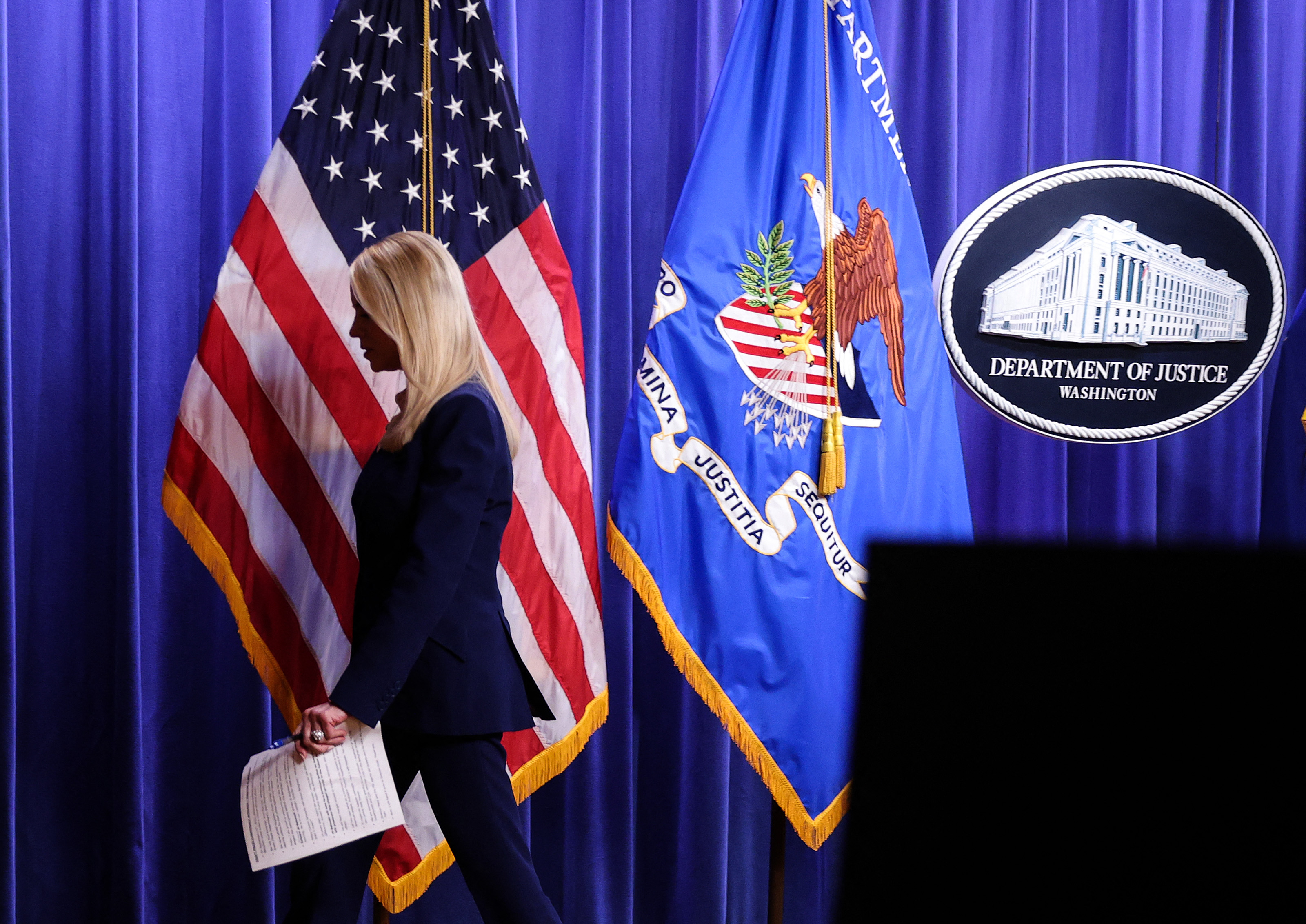 U.S. Attorney General Pam Bondi leaves after delivering remarks on an arrest connected to the 2012 U.S. Embassy attack in Benghazi