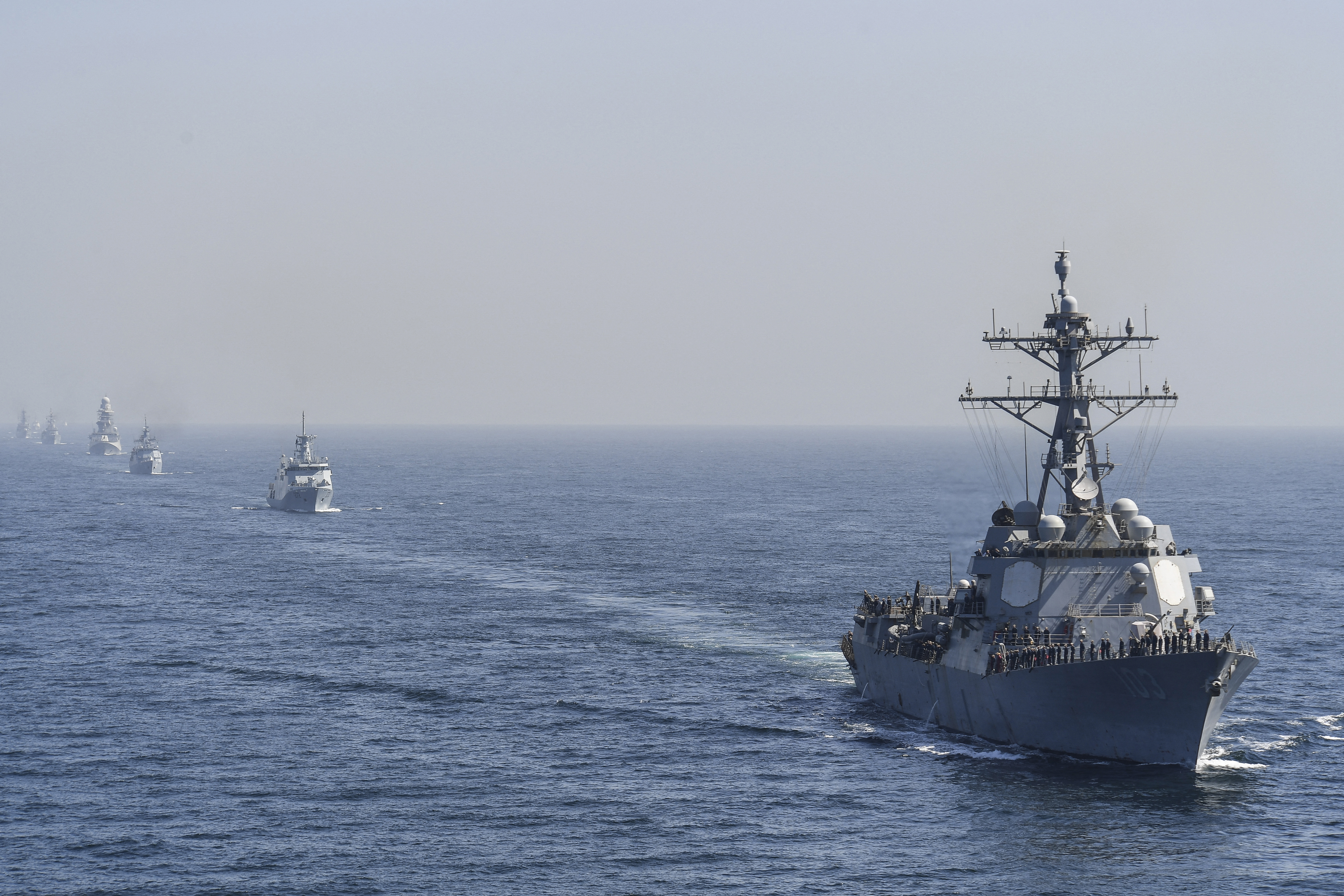 US Naval Ship USS Truxtun (R) and others participating countries ships take part in the multinational naval exercise 'AMAN-23' in the Arabian Sea near Pakistan's port city of Karachi