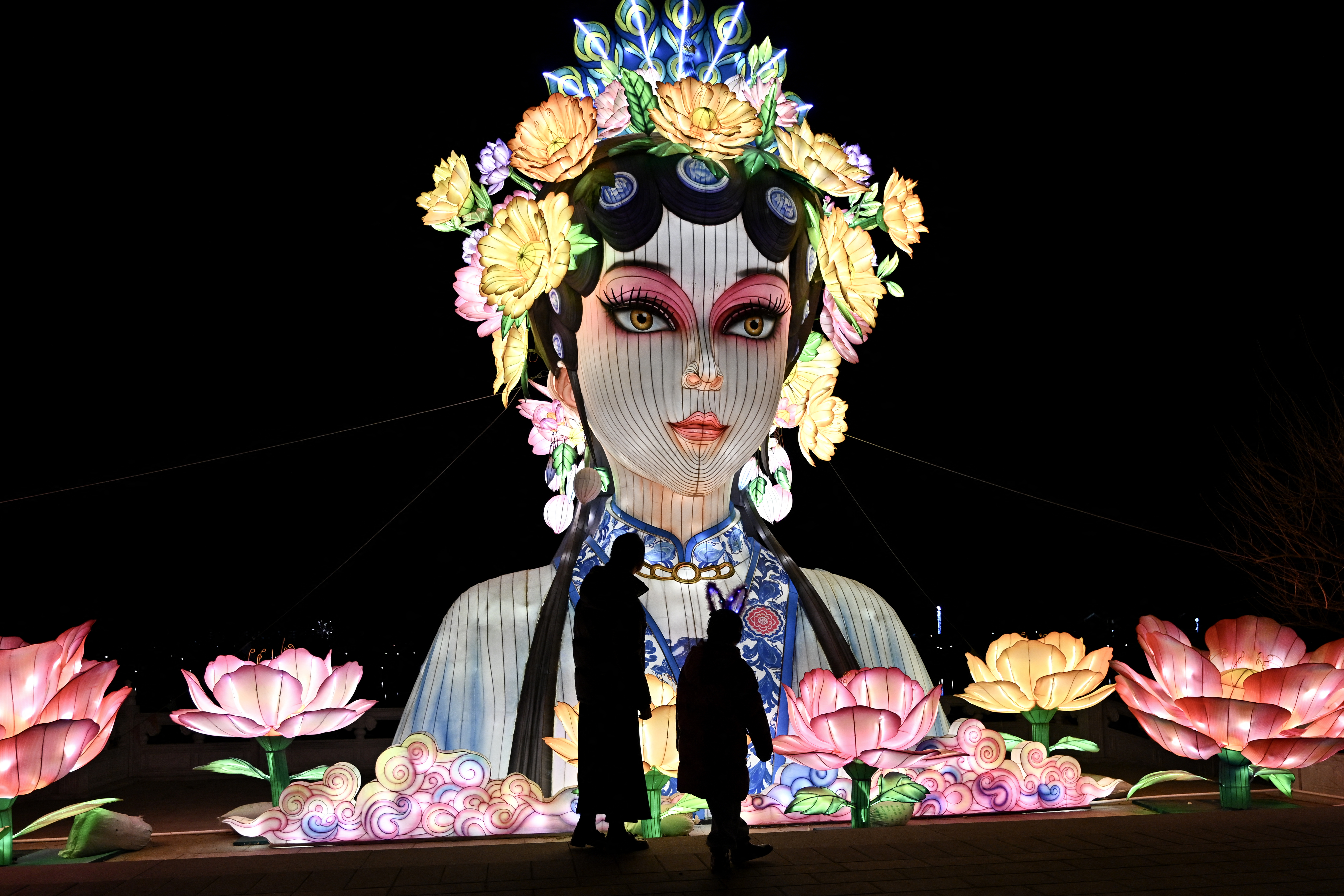 People visit a park in Beijing on February 15, 2026 ahead of the Lunar New Year of the Horse.