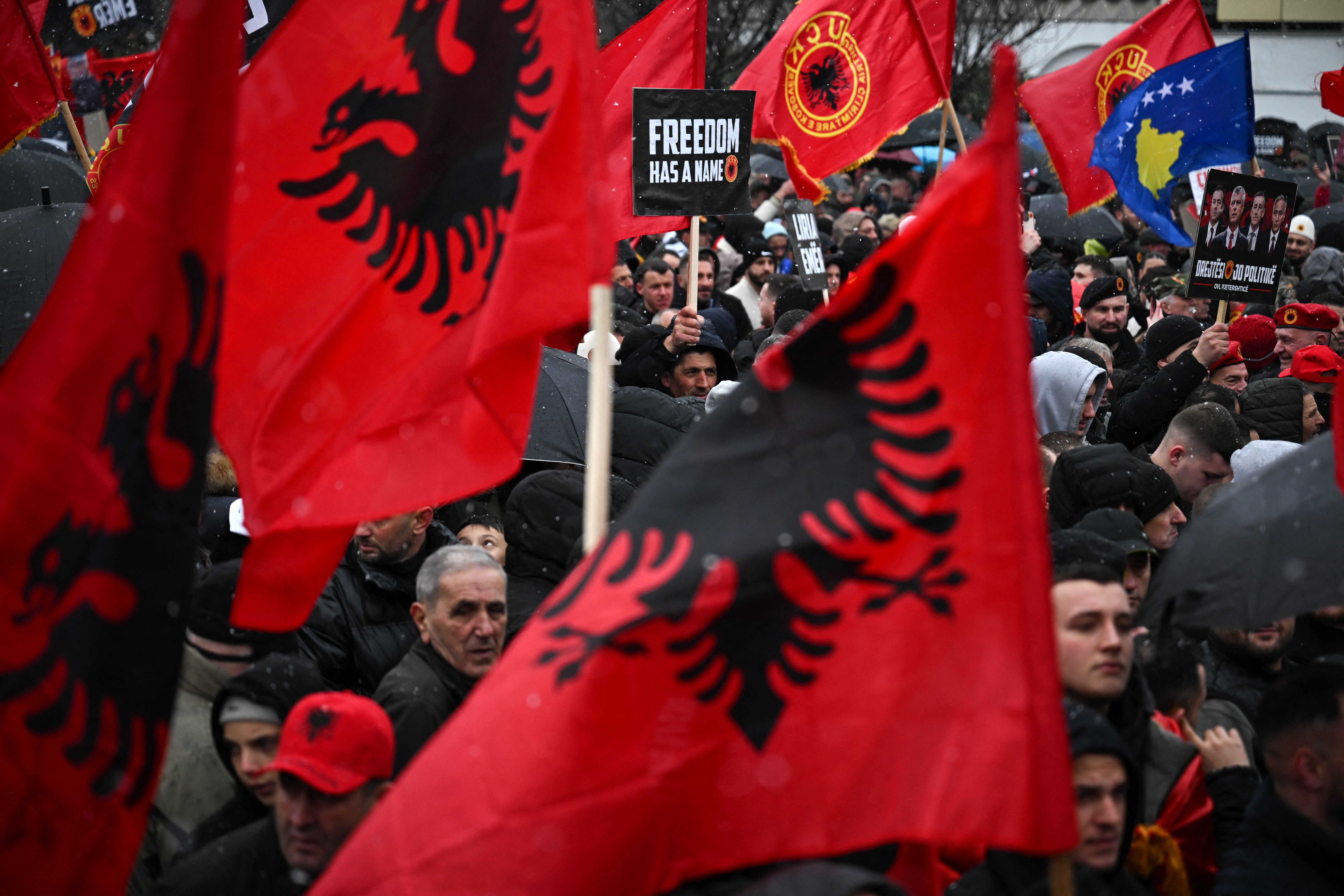 Kosovo Albanians demonstrate with flags in support of former Kosovo Liberation Army (KLA) leaders, including former Kosovo President Hashim Thaci, on trial at The Hague's international tribunal in downtown Pristina